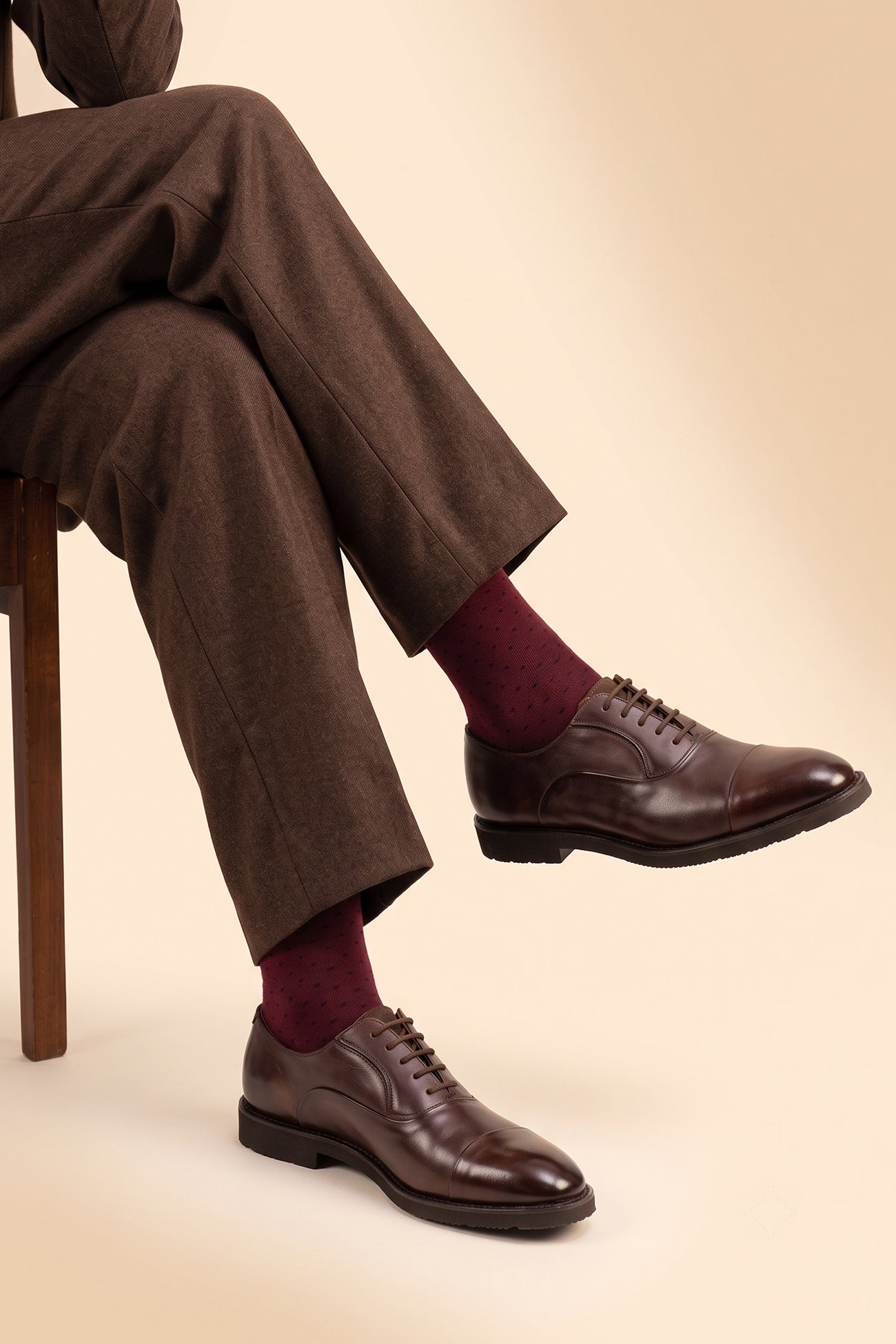 Model wearing Grayson brown Oxford leather shoes for men, classic formal footwear crafted from premium leather, ideal for smart business or evening wear.