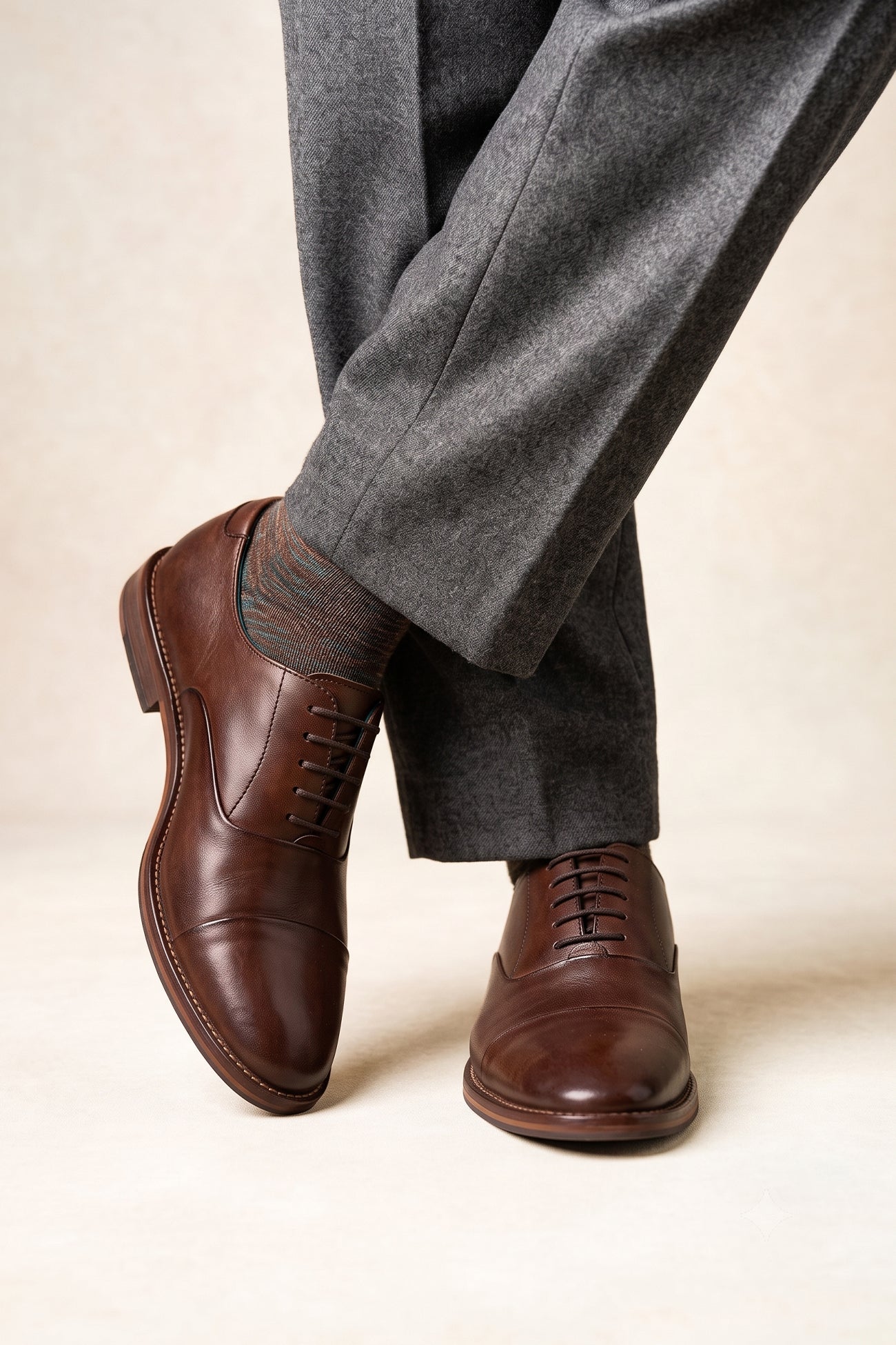 Model wearing Jarred Brown mens premium leather Oxford shoes featuring a distinctive toecap design and a polished brown finish.