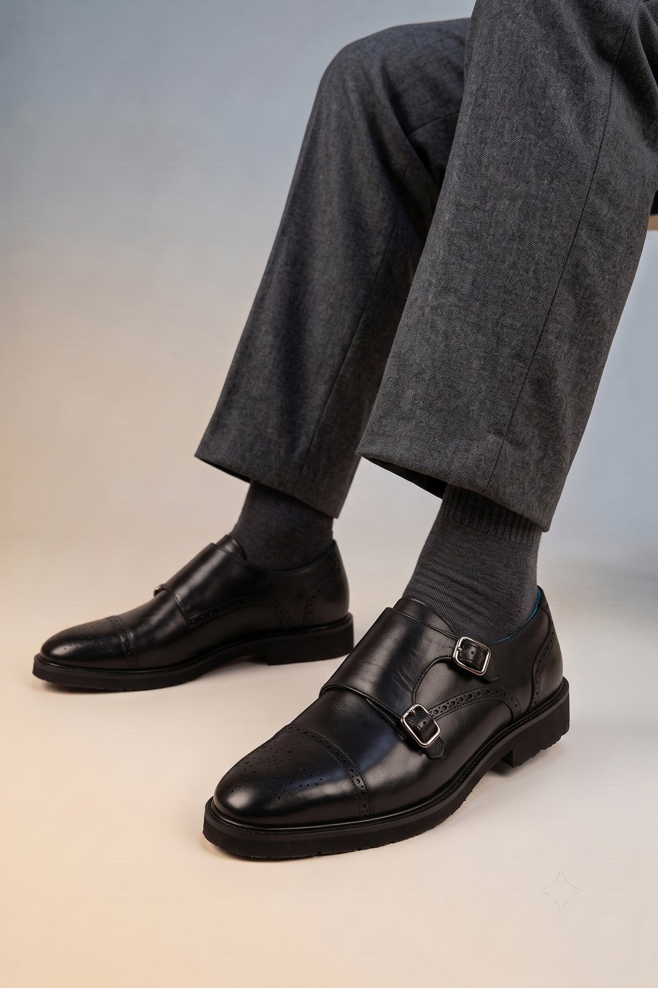 Model wearing Shelby Black monk strap brogue men’s leather shoes featuring detailed brogue pattern and premium black leather for formal and smart wear.