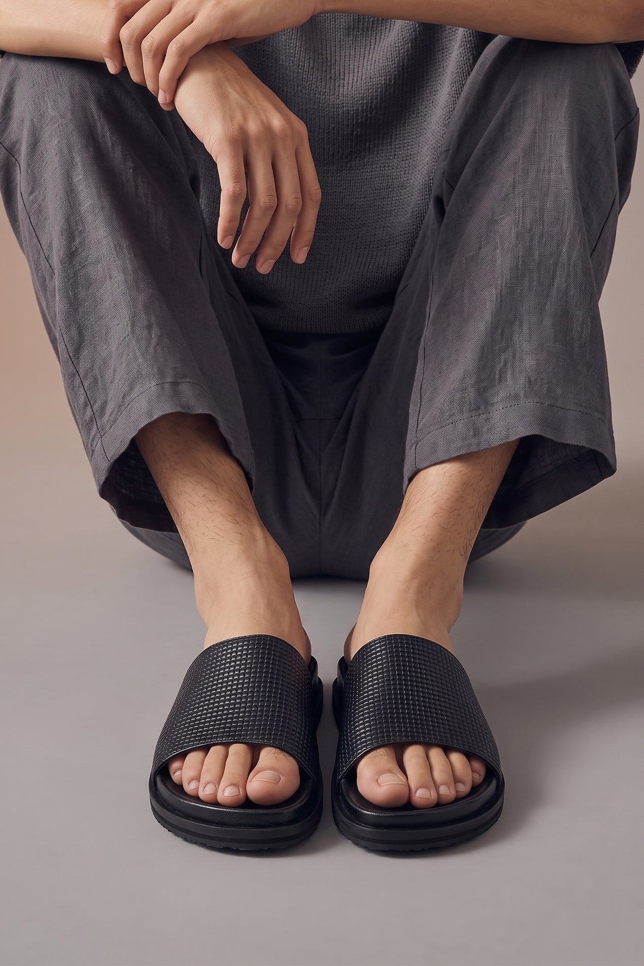 Model wearing Tito Black leather woven strap sandals for men by Oswin Hyde with stylish design and comfortable fit