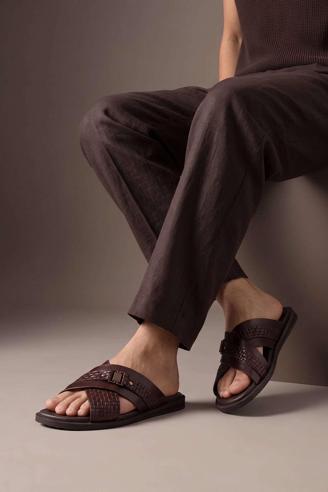 Model wearing Aiden Brown men’s leather sandals with a unique woven criss-cross strap design.