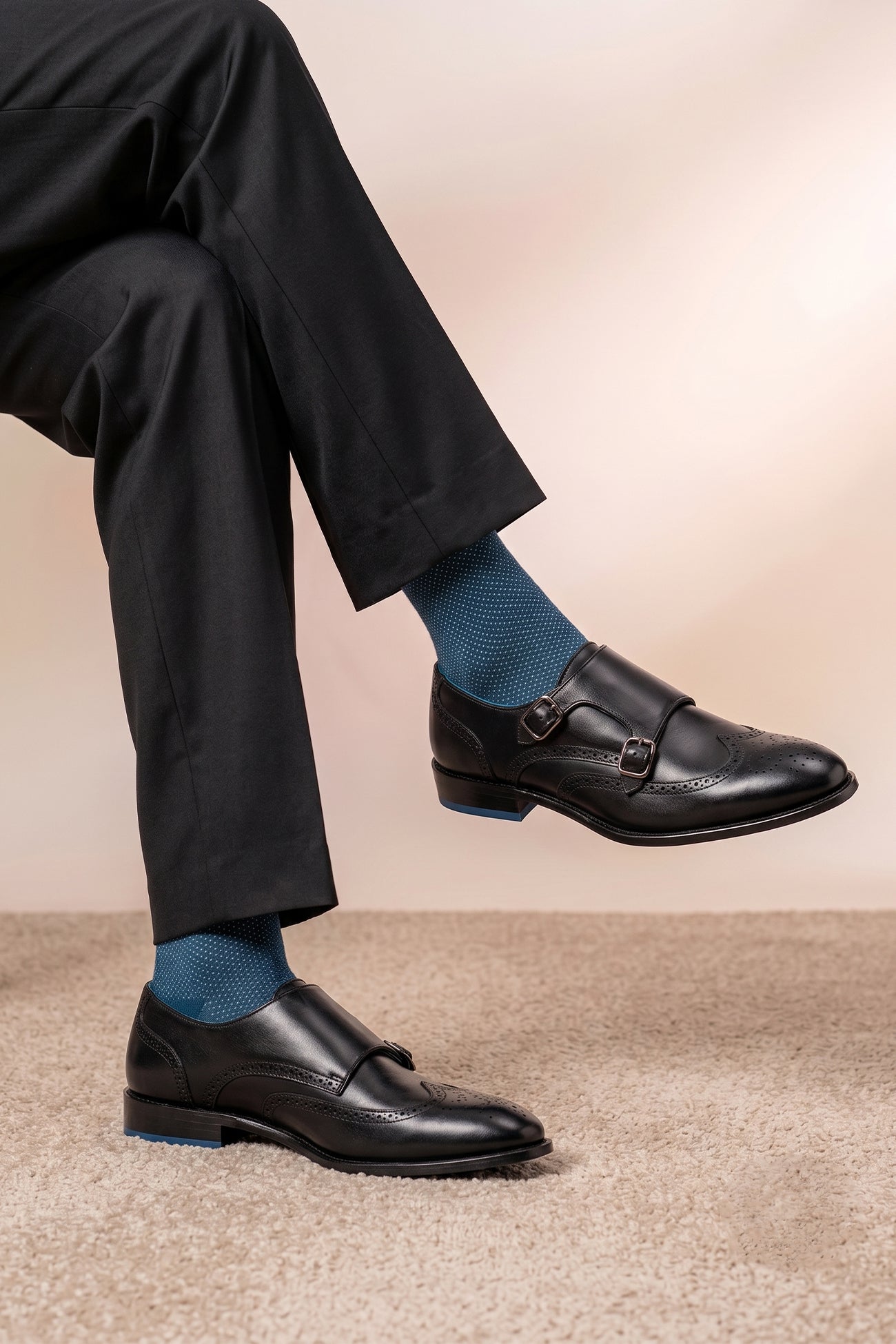 Model wearing Warren Black leather monk strap brogue shoes for men with wing cap detailing, perfect for formal and smart-casual occasions.