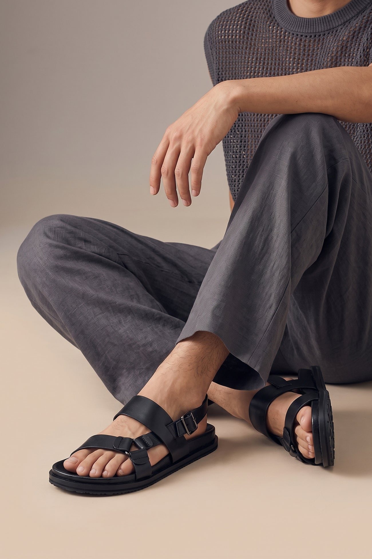 Model wearing Saxon Black leather ring strap sandals for men by Oswin Hyde with sleek design and comfortable fit