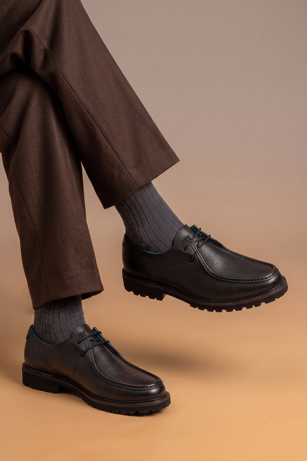 Model wearing Joshua black leather Wallabee shoes for men by Oswin Hyde – casual luxury footwear with moccasin-style stitching and premium comfort.