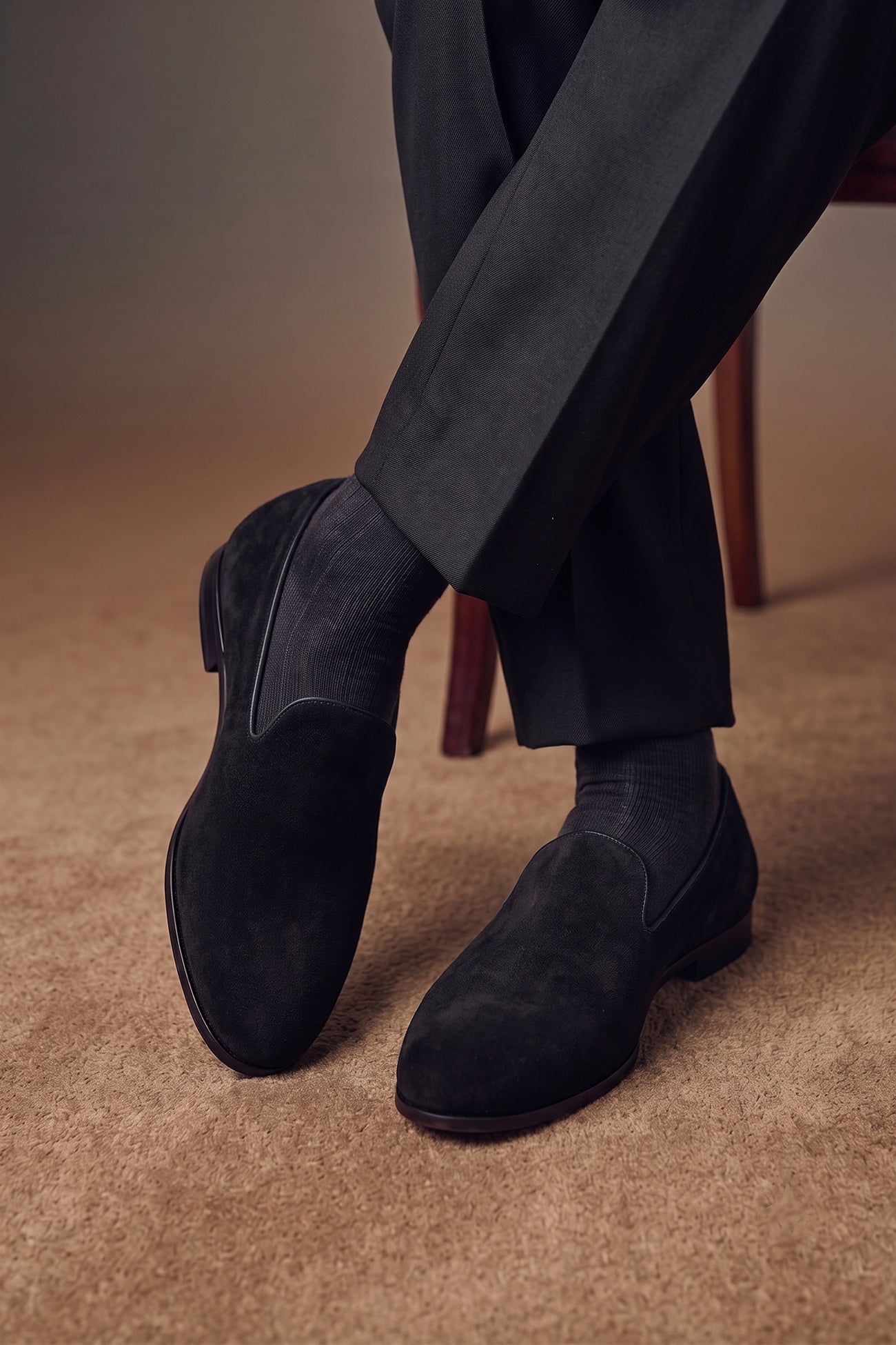 Model wearing Lennox black velvet loafers for men, designed for formal wear with smooth velvet finish and elegant silhouette.