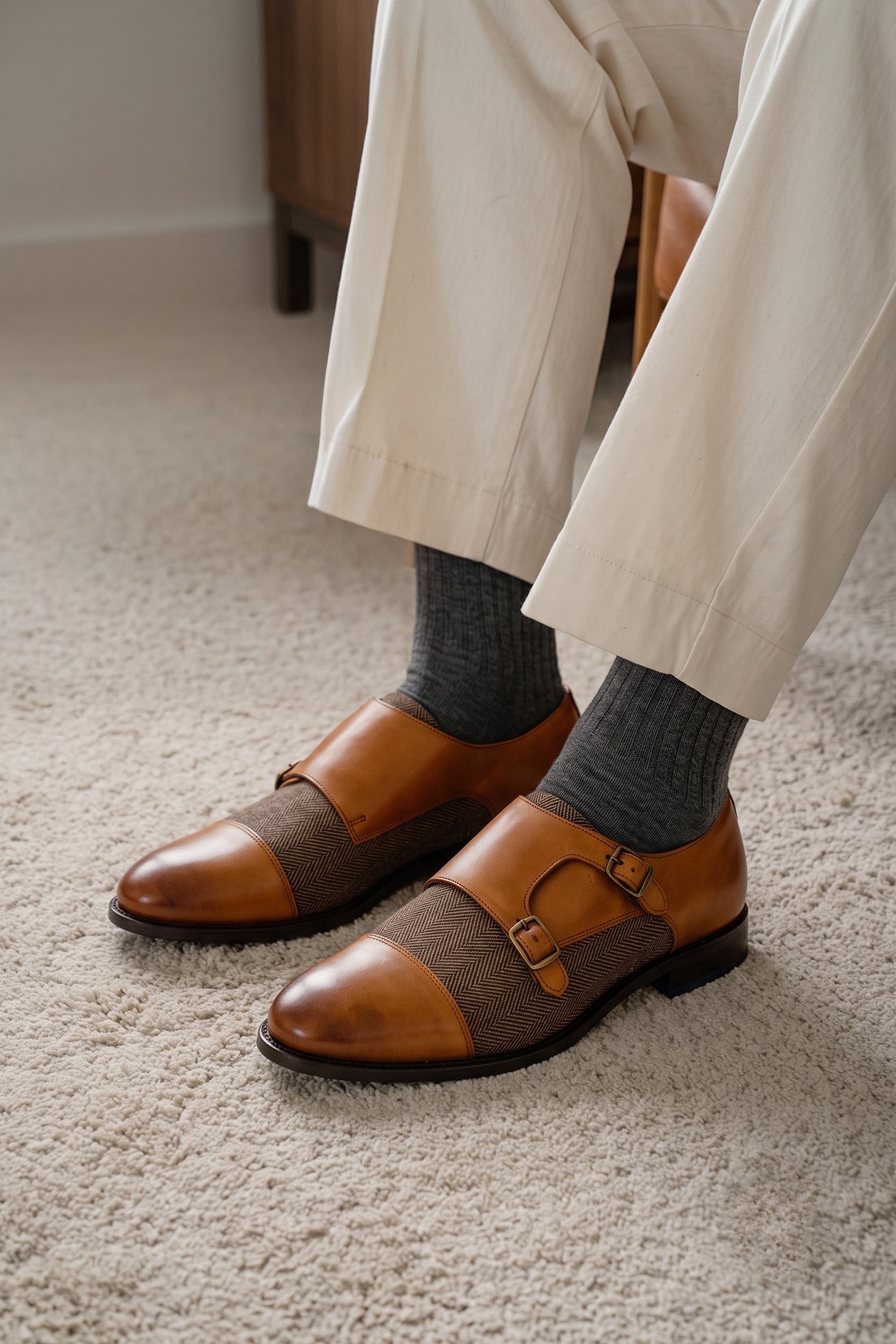 Model wearing Oscar cognac monk strap men’s shoes crafted from premium leather with tweed accents, ideal for formal and smart-casual occasions.