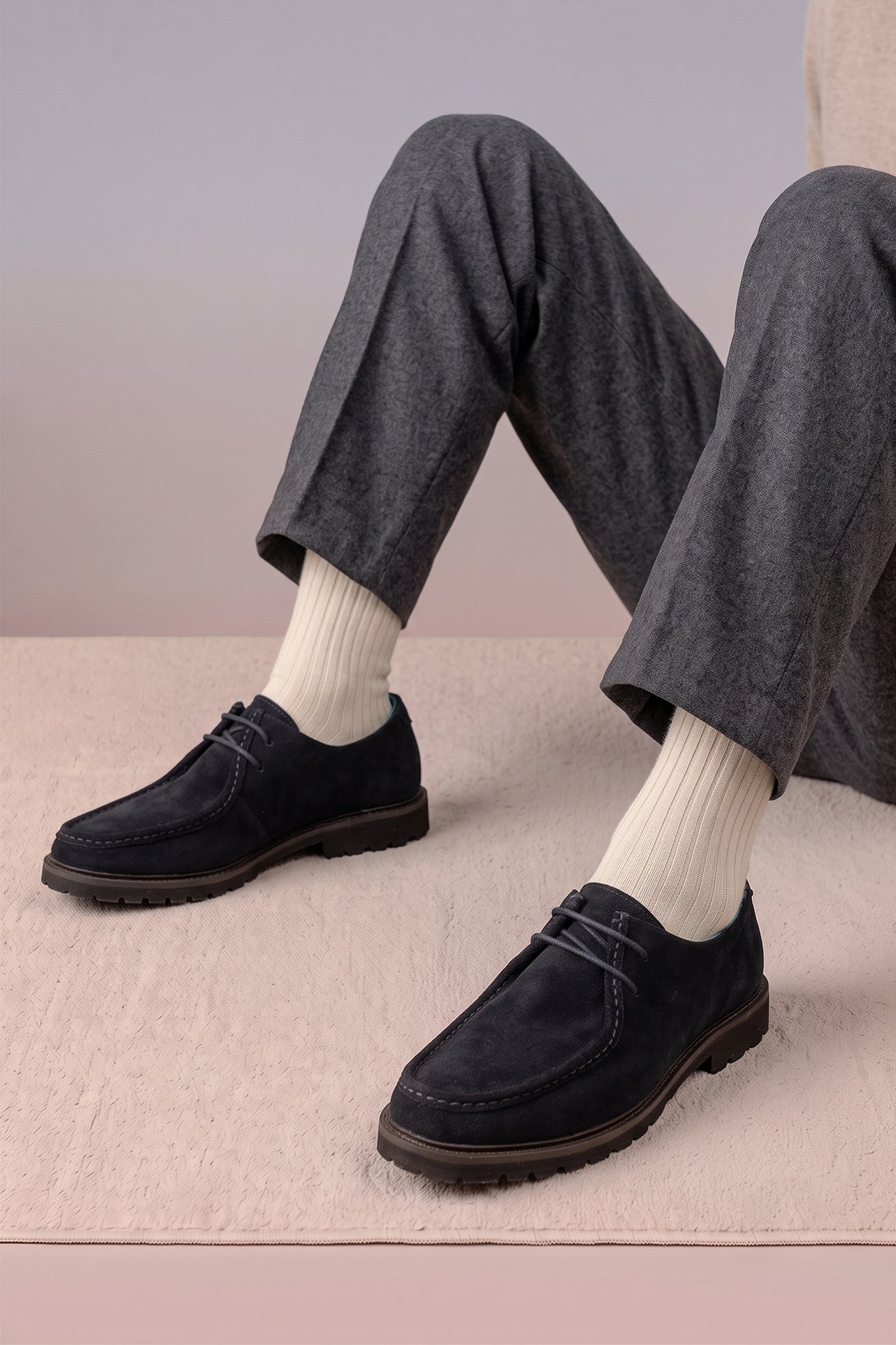 Model wearing Joshua navy suede Wallabee shoes for men by Oswin Hyde – luxurious casual moccasin-style footwear with soft suede and cushioned insole for all-day comfort.