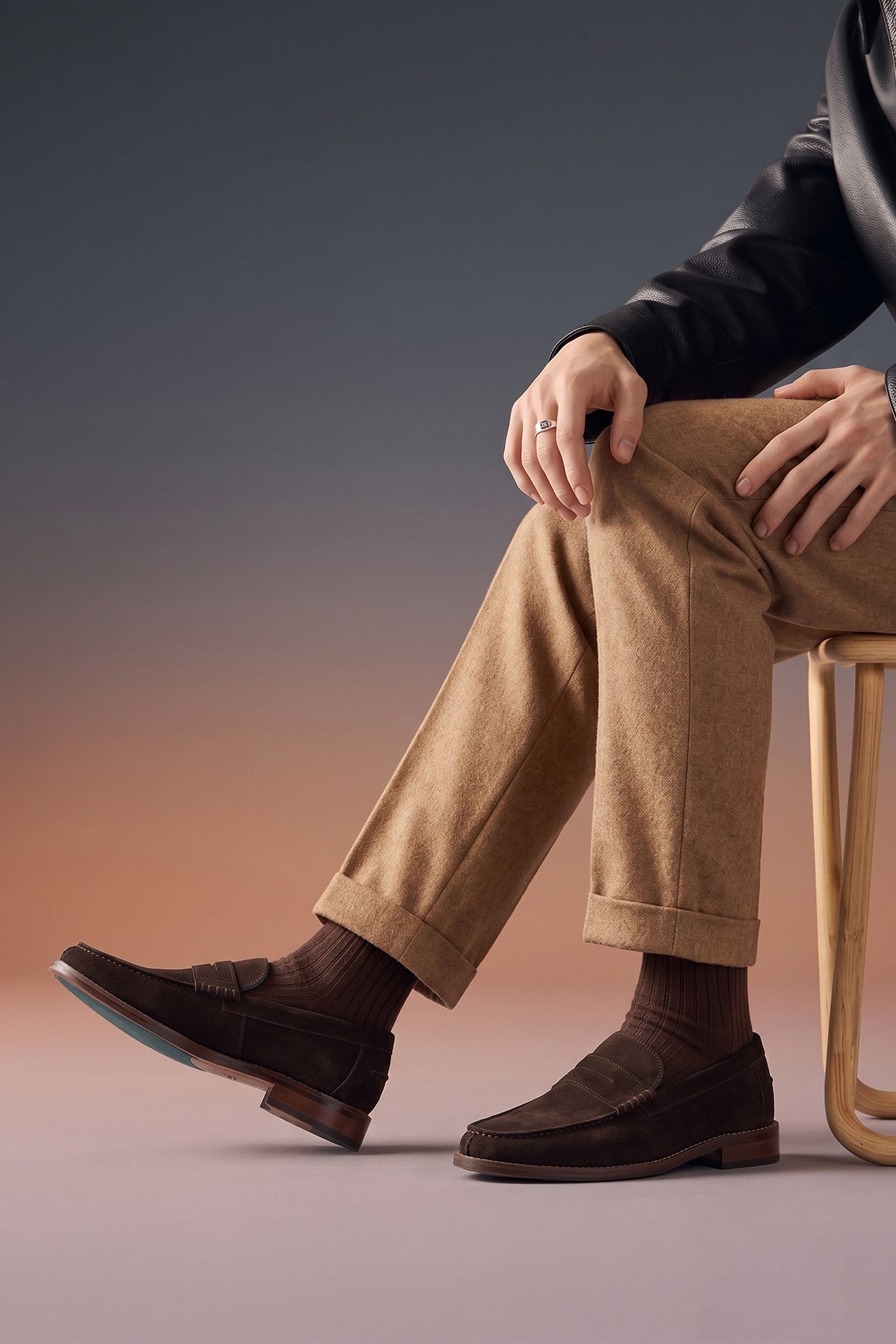 Model wearing Peter Brown Suede leather penny loafers for men. Classic and stylish, these loafers provide comfort, durability, and a refined look for any occasion.