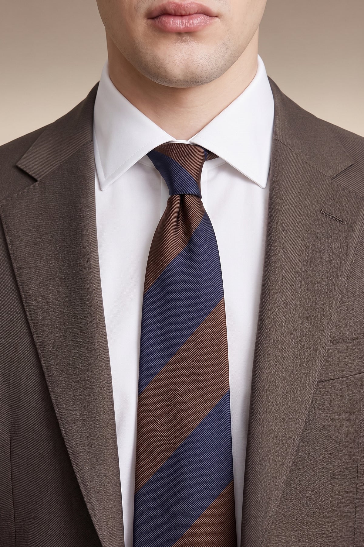 Man wearing  Brown Navy Stripes tie for men, designed to add a classic touch to any outfit. Featuring a stylish blend of brown and navy stripes