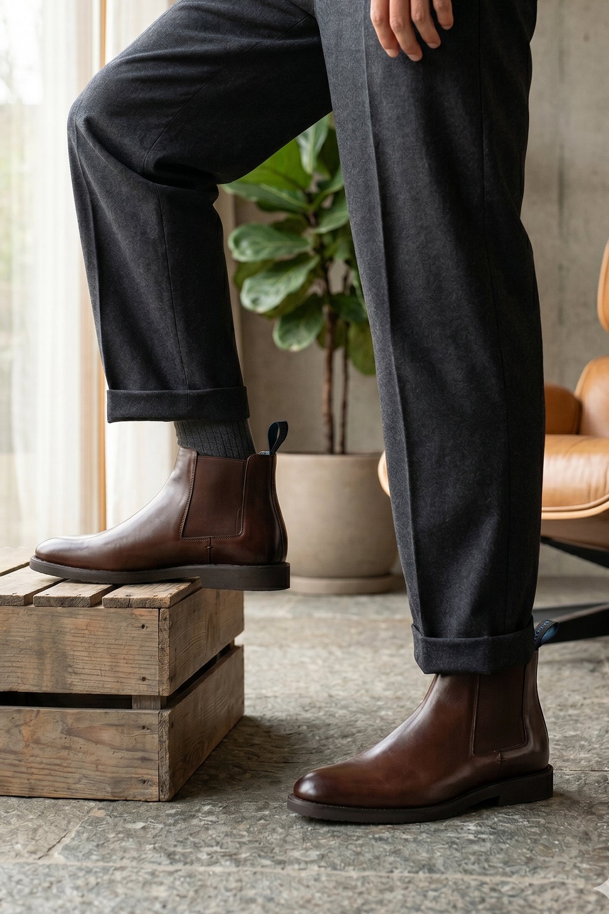 Man wearing Christopher Brown Chelsea boots for men, crafted from premium leather with handmade soles, offering luxury, refined style, and high-quality craftsmanship.
