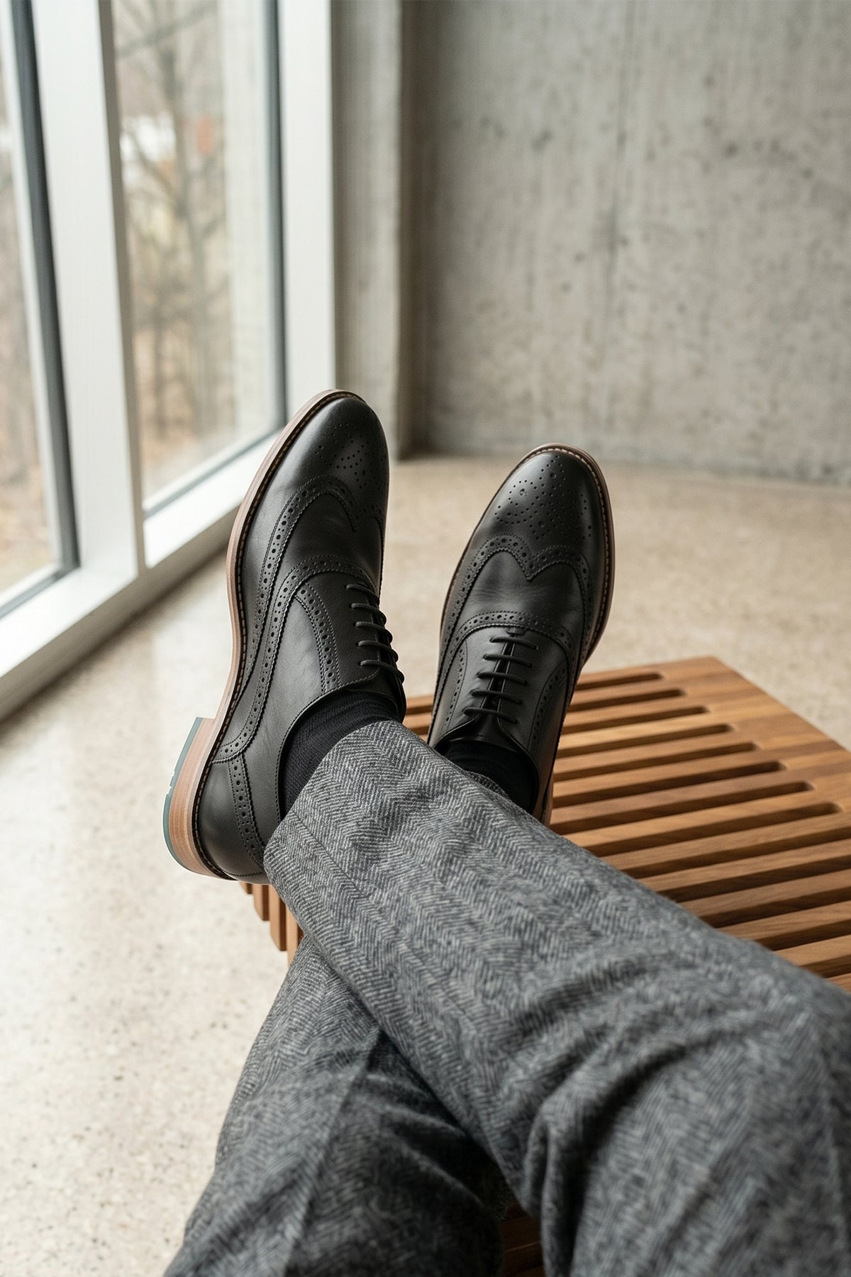Man wearing Winston Black Brogue Oxford leather shoes for men with classic perforated detailing and polished finish, ideal for formal and professional occasions.