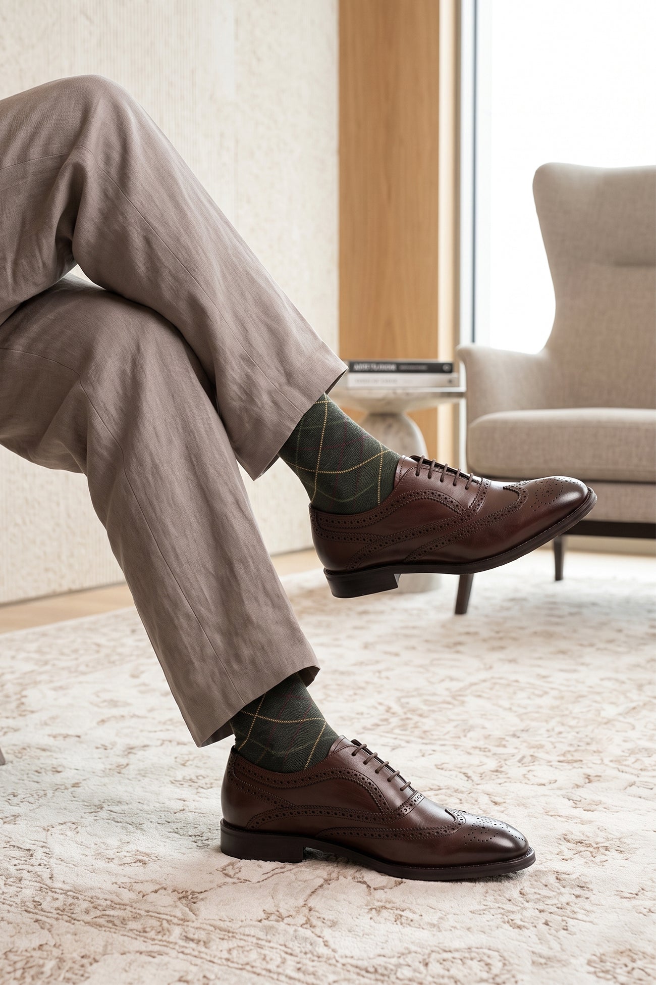 Model wearing Stokes Brown Oxford Brogue Wing Cap leather shoes for men, crafted with premium brown leather and intricate brogue detailing for formal style.