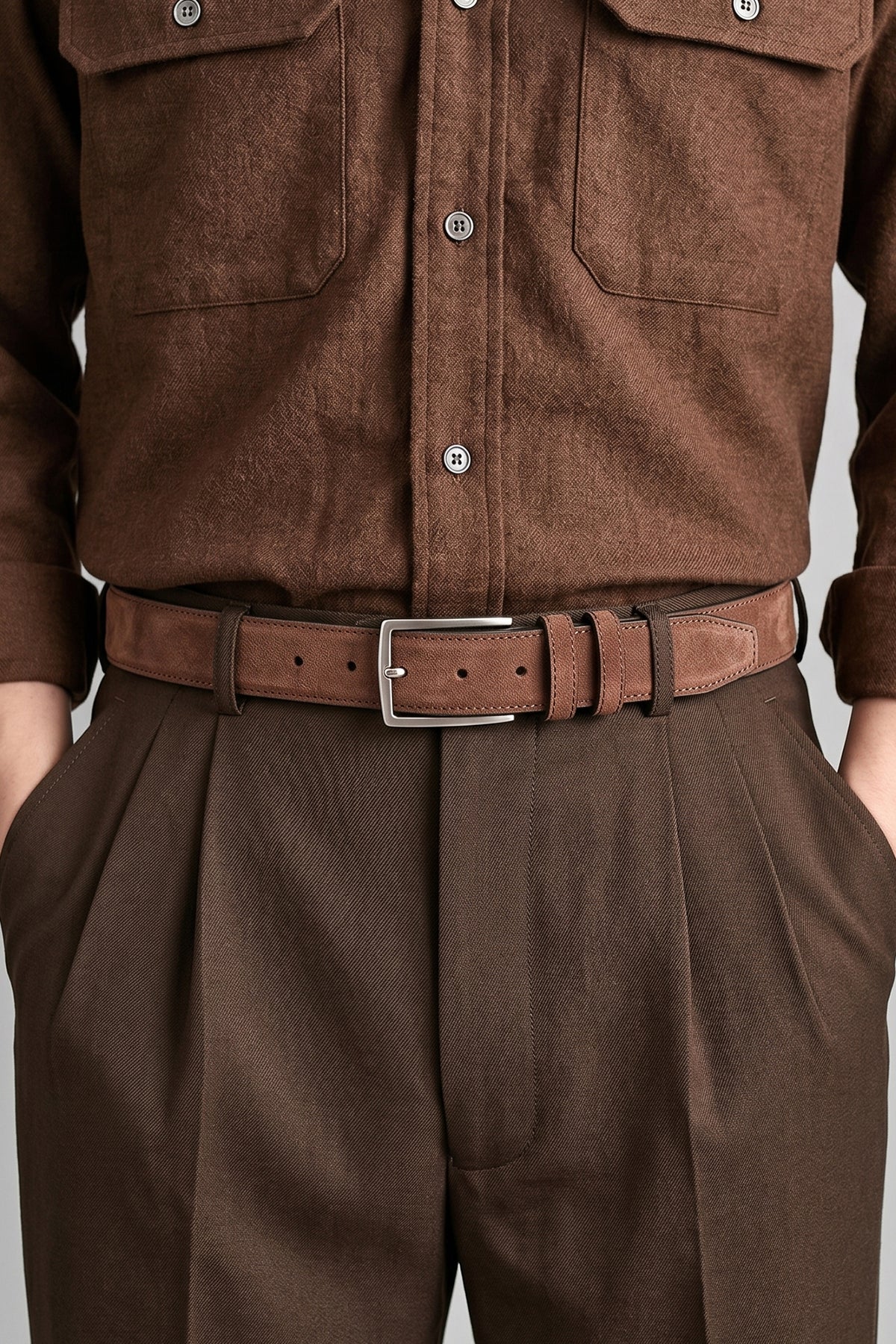 Man wearing Kenneth Brown suede leather belt for men. Featuring a classic pin buckle, this belt combines style and durability with a soft suede finish.