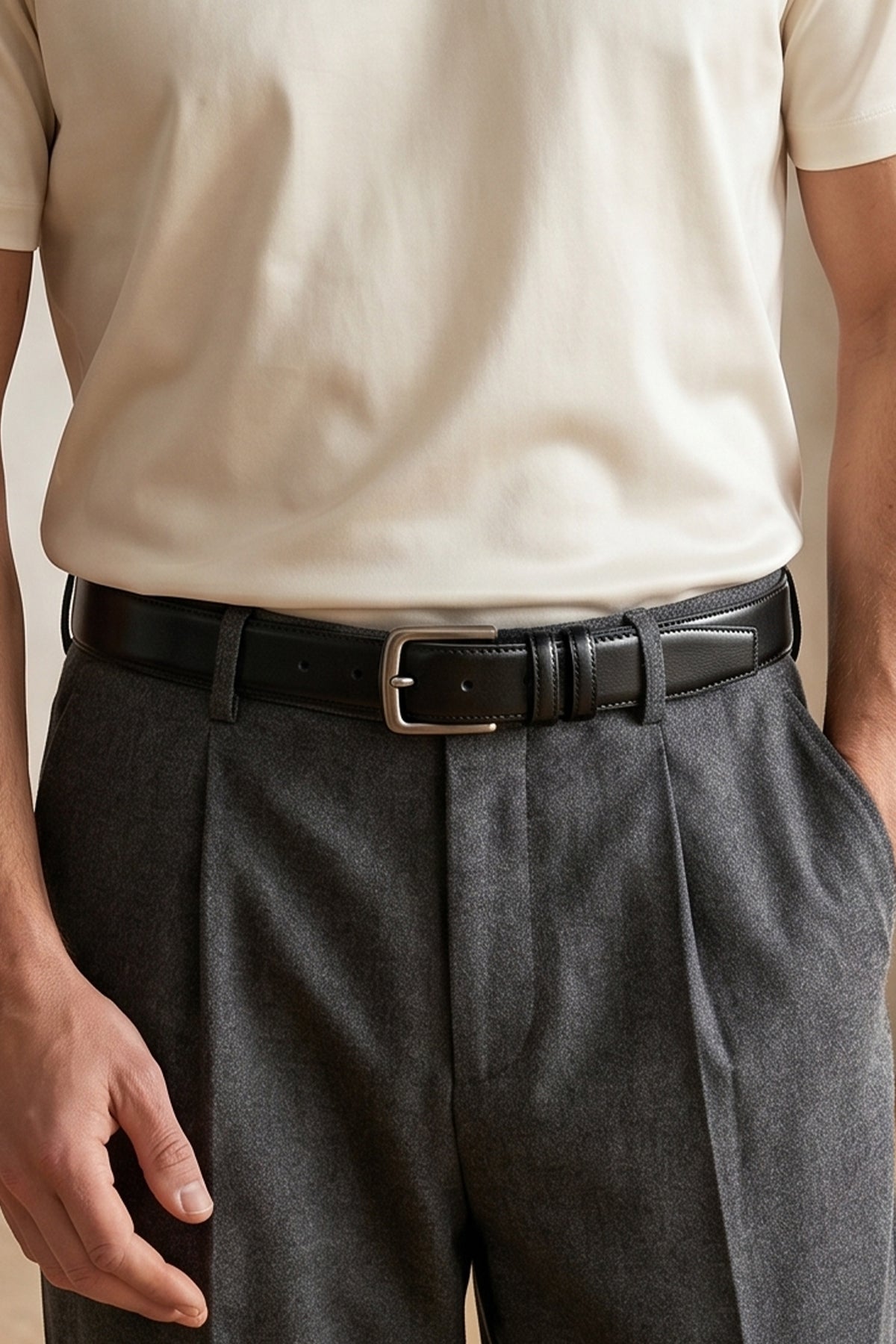 Man wearing Oswin Hyde Neil Black men’s leather belt - Premium black full-grain leather with brushed steel buckle, designed for formal occasions, business wear and smart casual outfits
