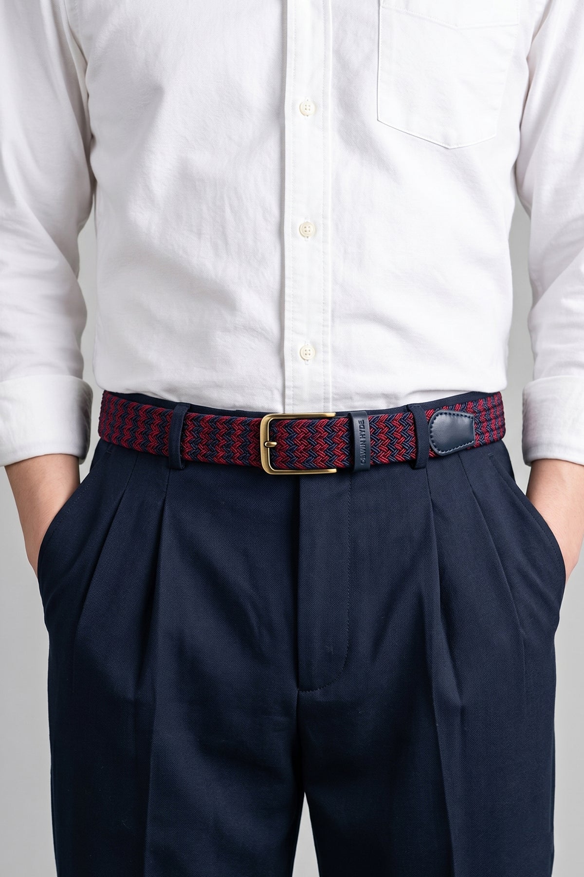 Man wearing Oswin Hyde Clyde belt - Red and blue elastic webbing with leather trim, for weddings and smart-casual