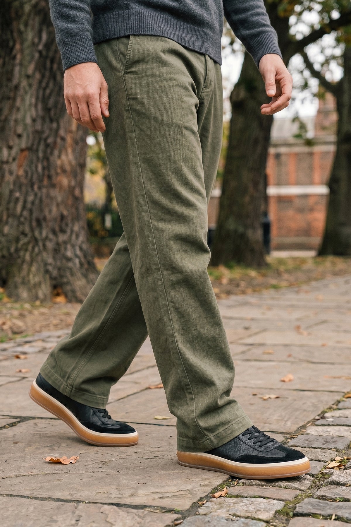 Model wearing  Smith Black leather sneakers for men, featuring a sleek seven-eyelet design that exudes modern elegance. Crafted from premium leather.