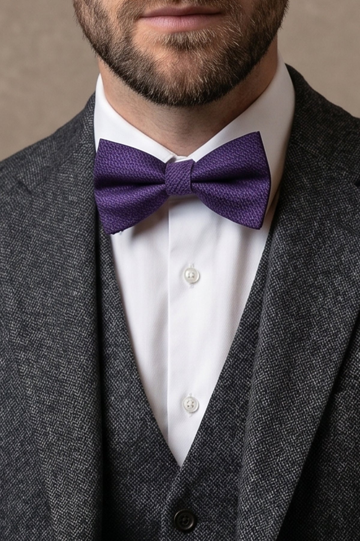 Man wearing Oswin Hyde Purple Scotch Texture Bowtie for men, designed with a distinctive scotch-textured pattern