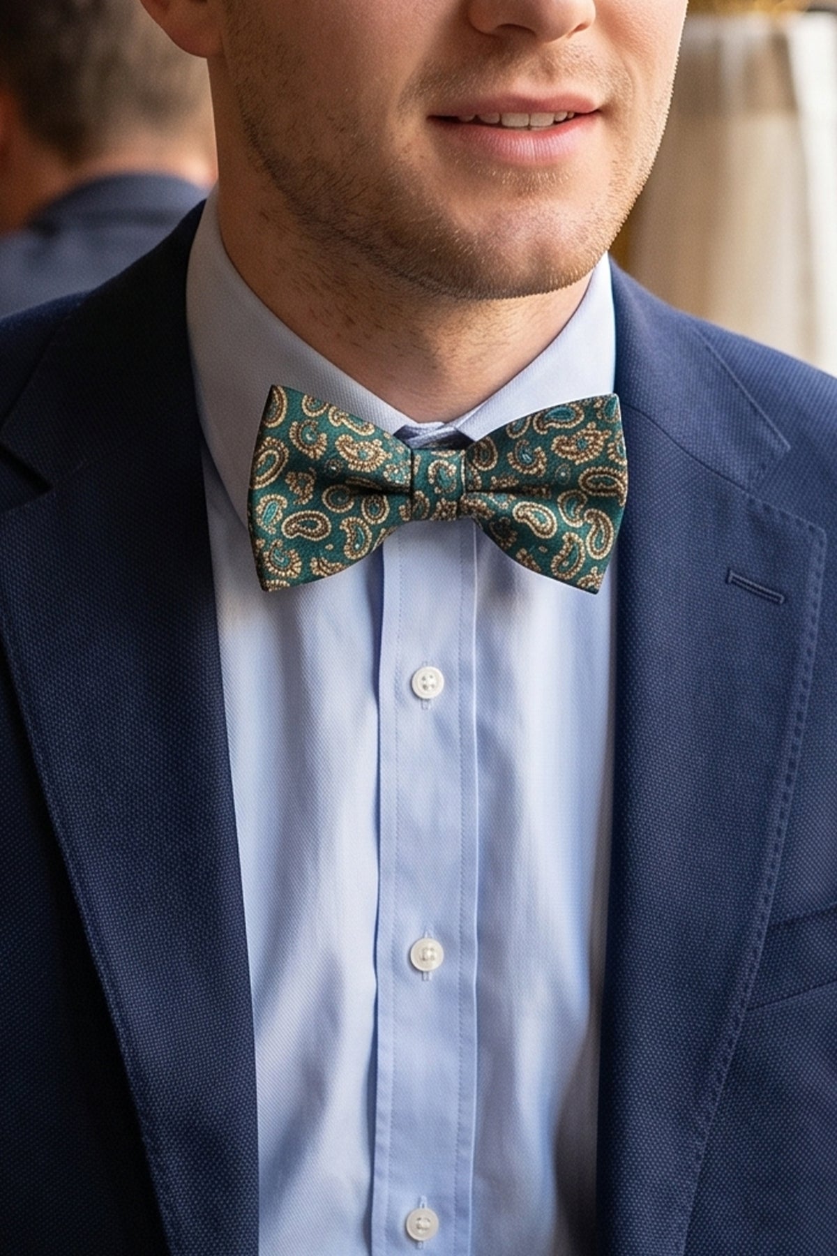 Man wearing Paisley Pattern Green Bowtie for men, crafted with a beautiful paisley design. Rich green colour and intricate design.