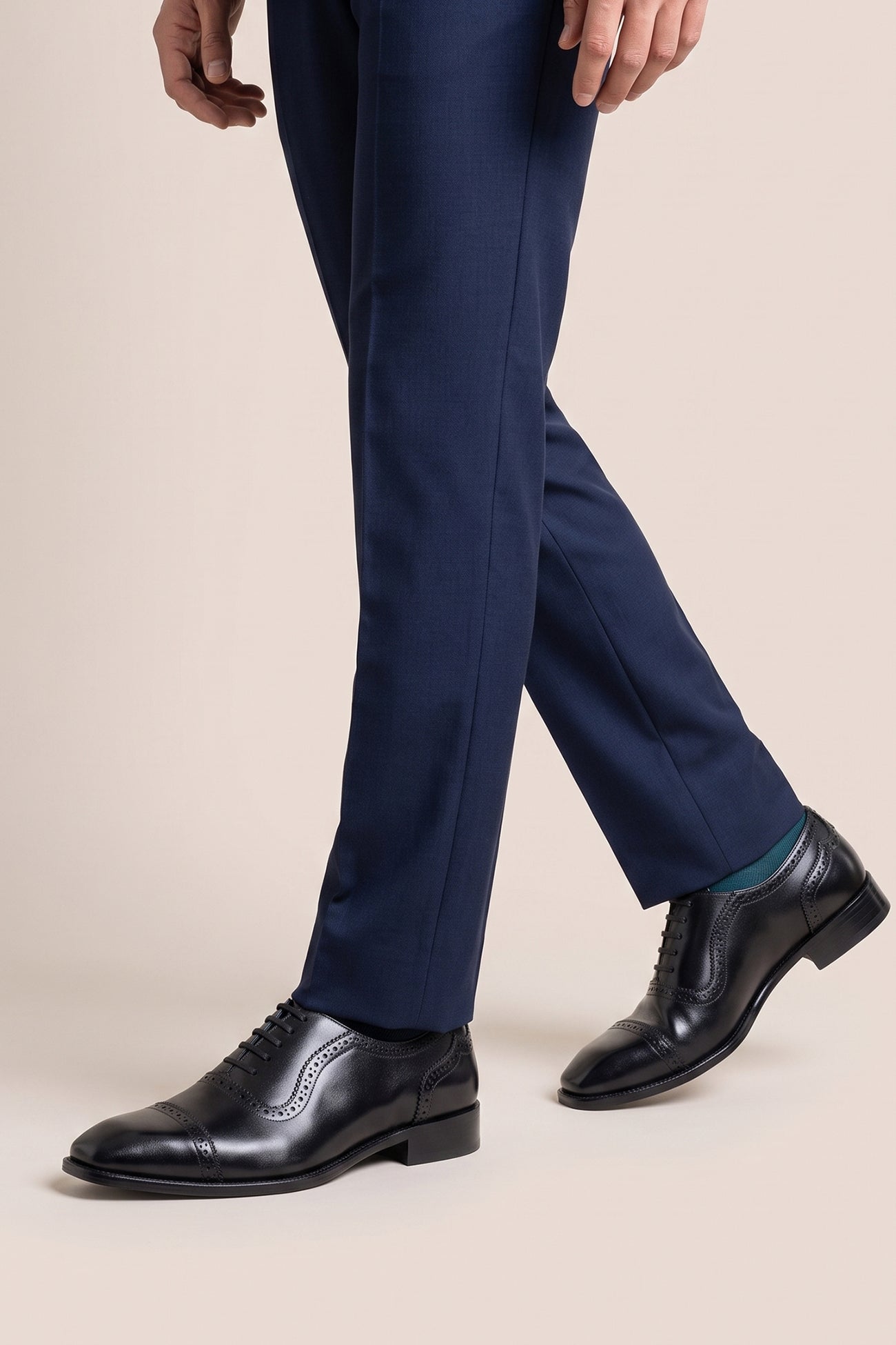 The men's smart black shoes showcase a sleek cap-toe design with delicate brogue punch detailing and premium full-grain leather, perfect for business settings, weddings, and formal occasions.