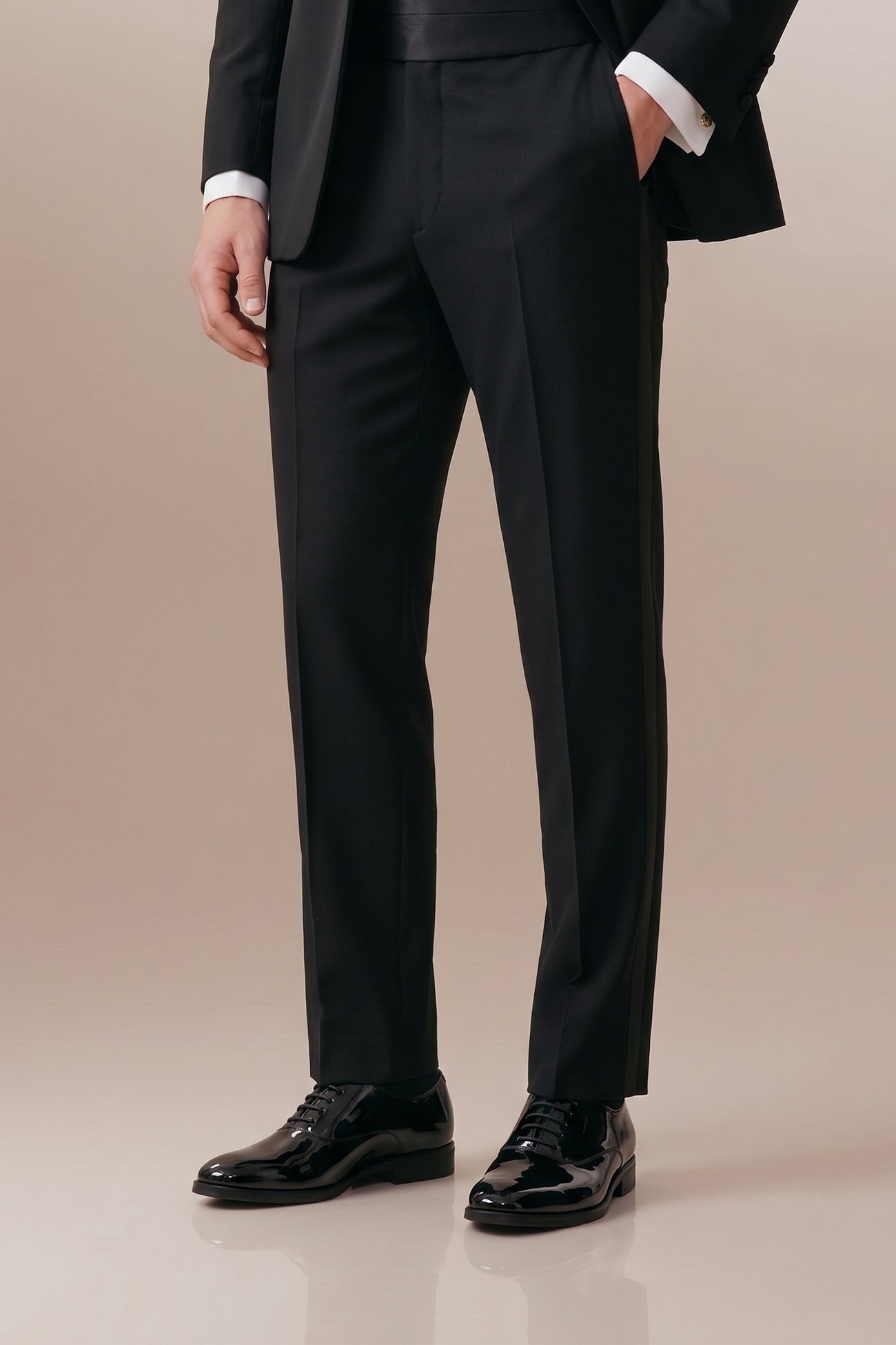 Model wearing Bow Black men's leather patent shoes. The men's smart black shoes exude luxury and sophistication, perfect for weddings