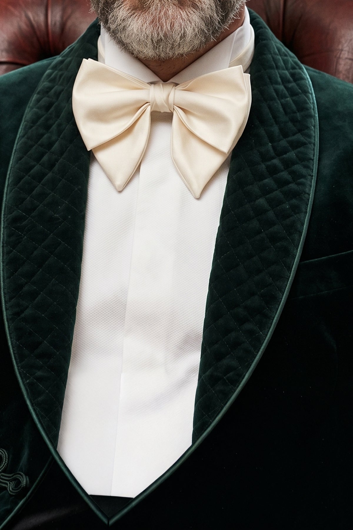 Man wearing Oswin Hyde Cream Velvet Retro Bowtie, meticulously crafted from smooth velvet to offer a classic yet stylish look