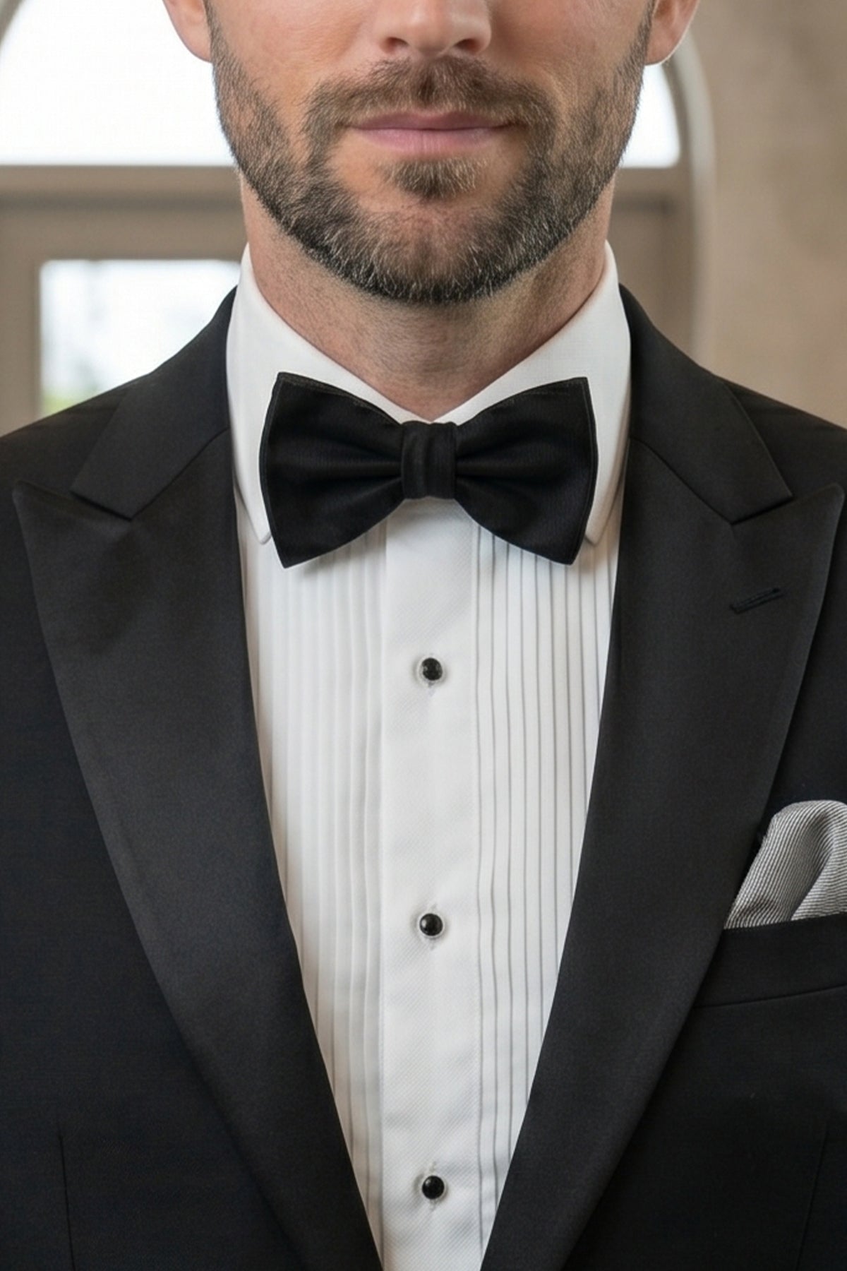 Man wearing Black Silk Bow Tie with luxurious design, perfect for weddings and formal events.