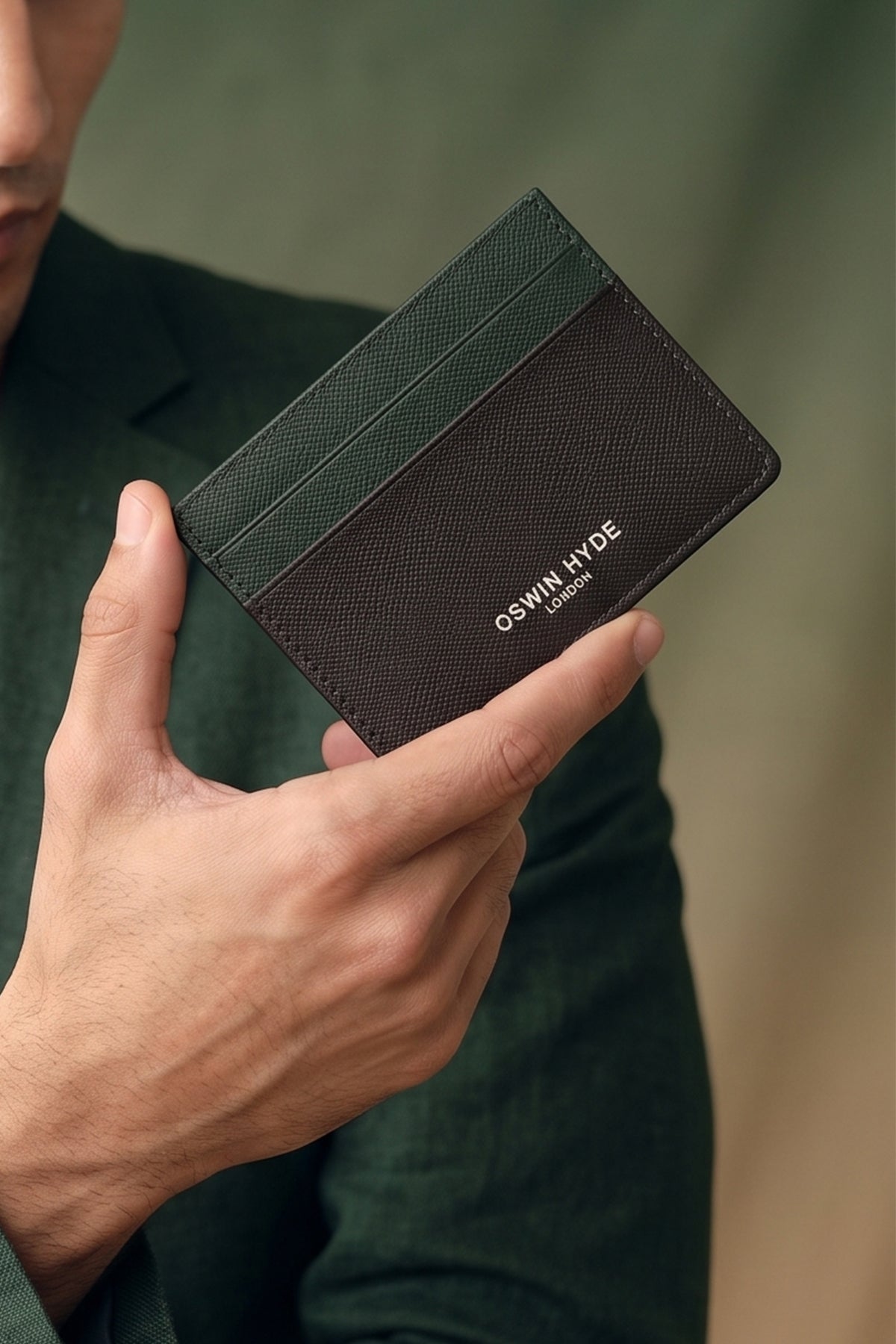 Man holding Holborn green saffiano leather card holder for men by Oswin Hyde – slim, luxury wallet with silver embossed logo and premium textured finish.