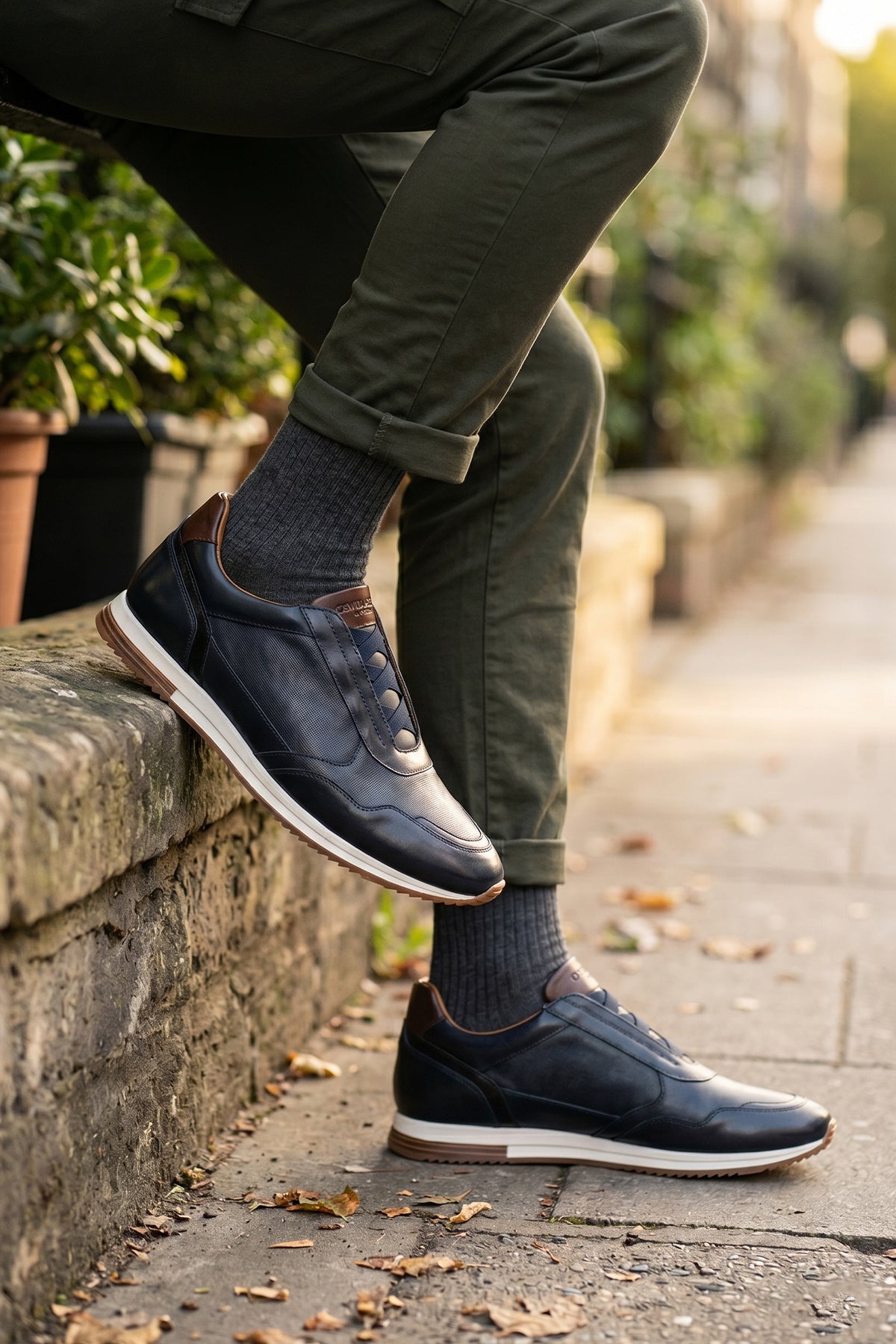Model wearing Colt Navy men's leather sneakers, featuring a clever elastic design that ensures a comfortable and secure fit. 