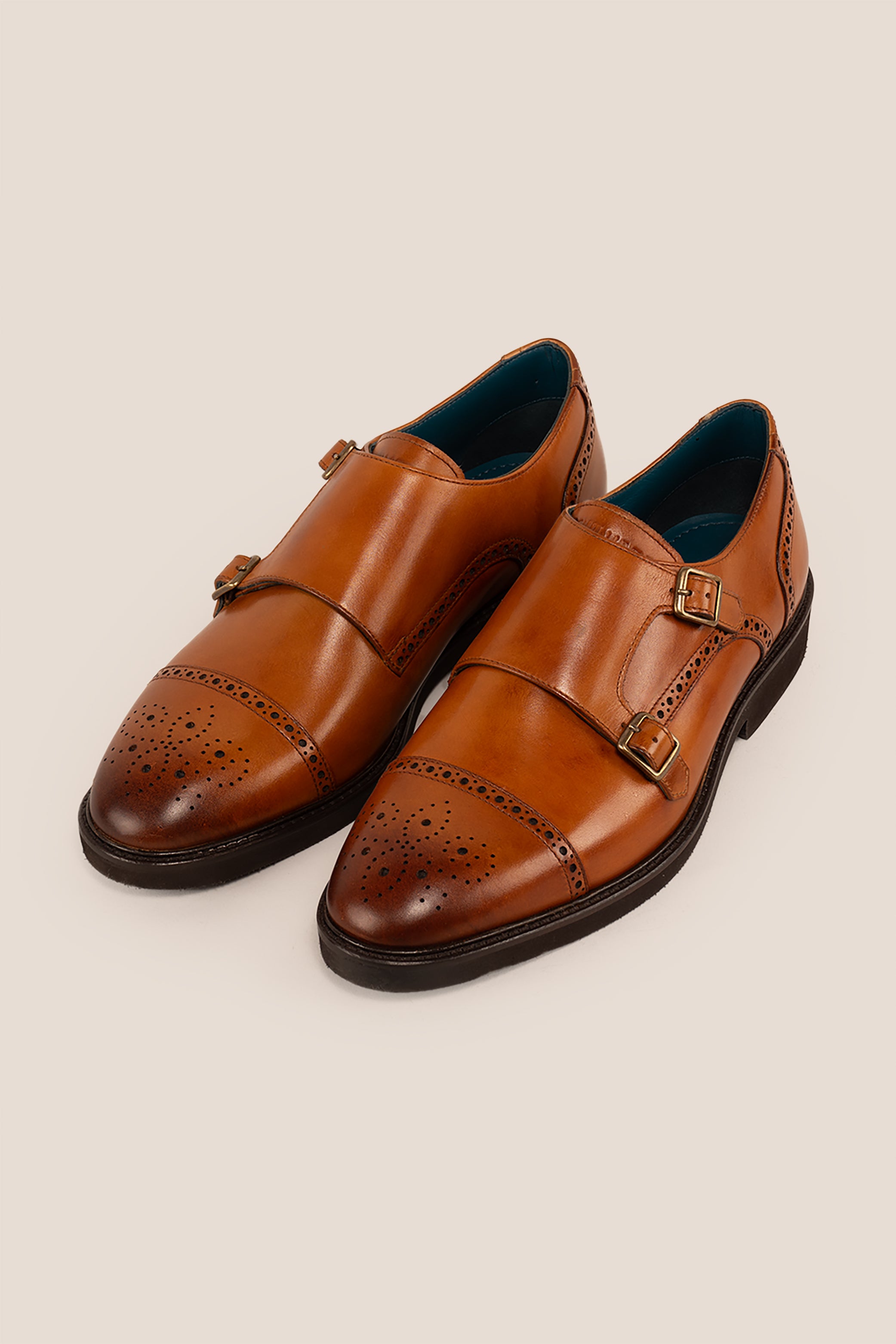 Men’s Shelby tan leather monk strap brogue shoes featuring intricate broguing and premium craftsmanship for formal and smart-casual occasions.