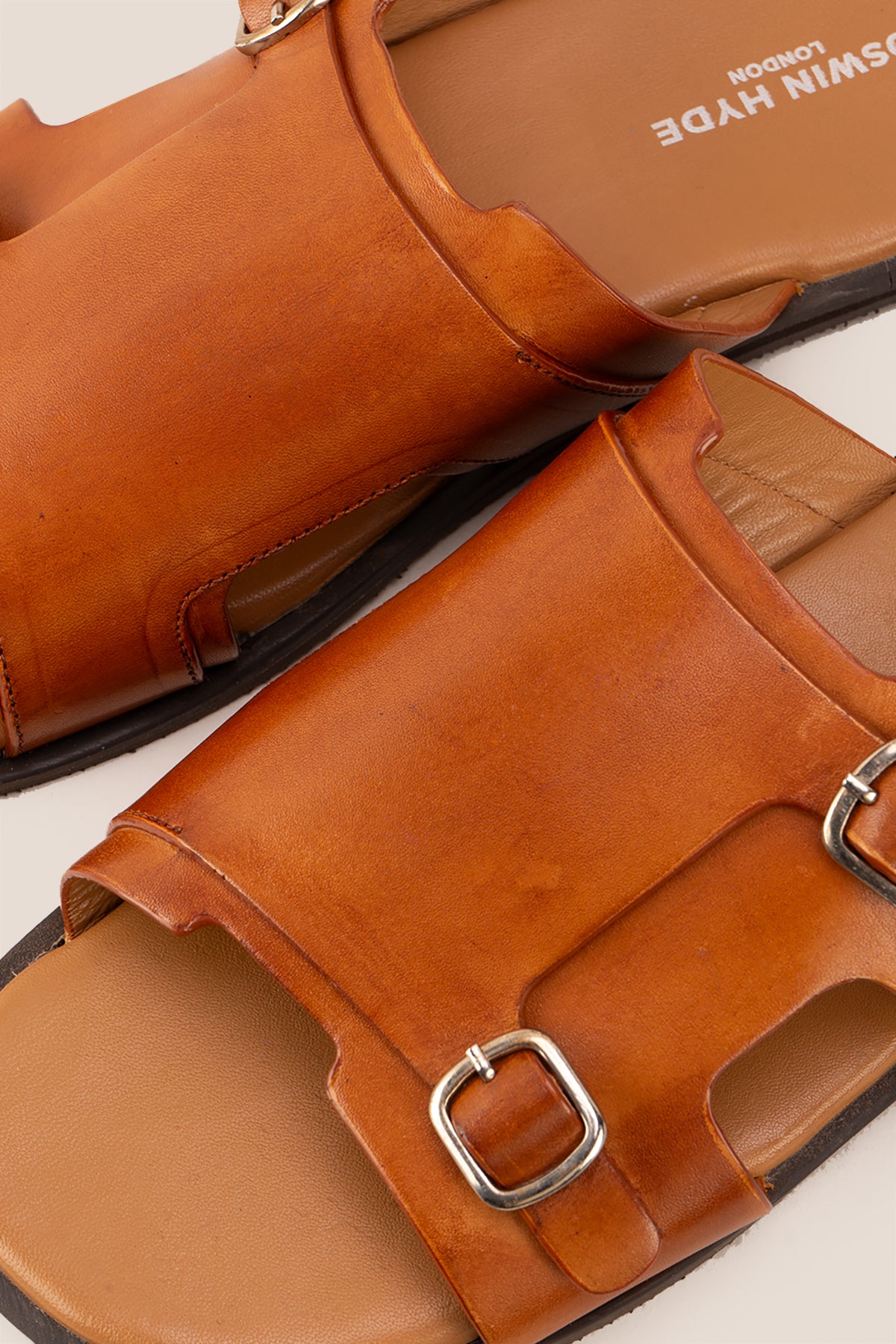 Logan tan leather sandals for men made from premium leather with open-toe design and stitched sole, ideal for summer comfort and smart-casual wear.