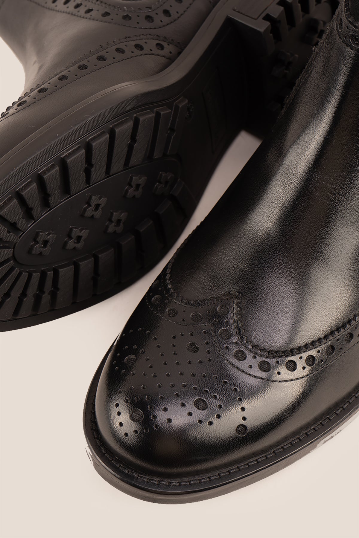 Gavin black leather Chelsea boots for men with intricate brogue detailing, showcasing timeless elegance and refined craftsmanship