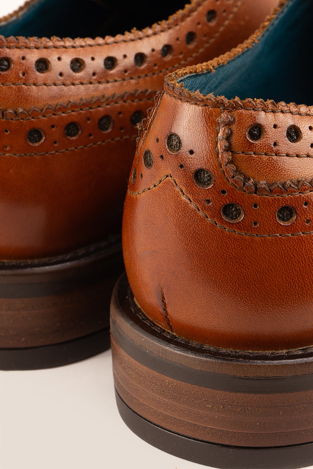 George Tan leather shoes for men. Featuring a five-eyelet wing cap brogue design, these shoes offer timeless style and comfort