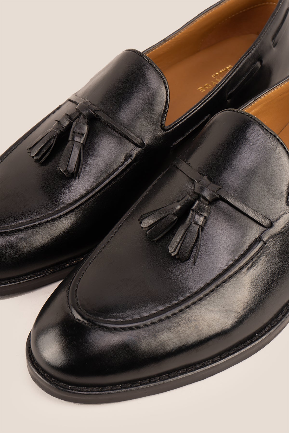 Issac Black Leather Tassel Loafers for men with cushioned sole, premium finish, and timeless style—ideal for formal wear and smart-casual outfits.