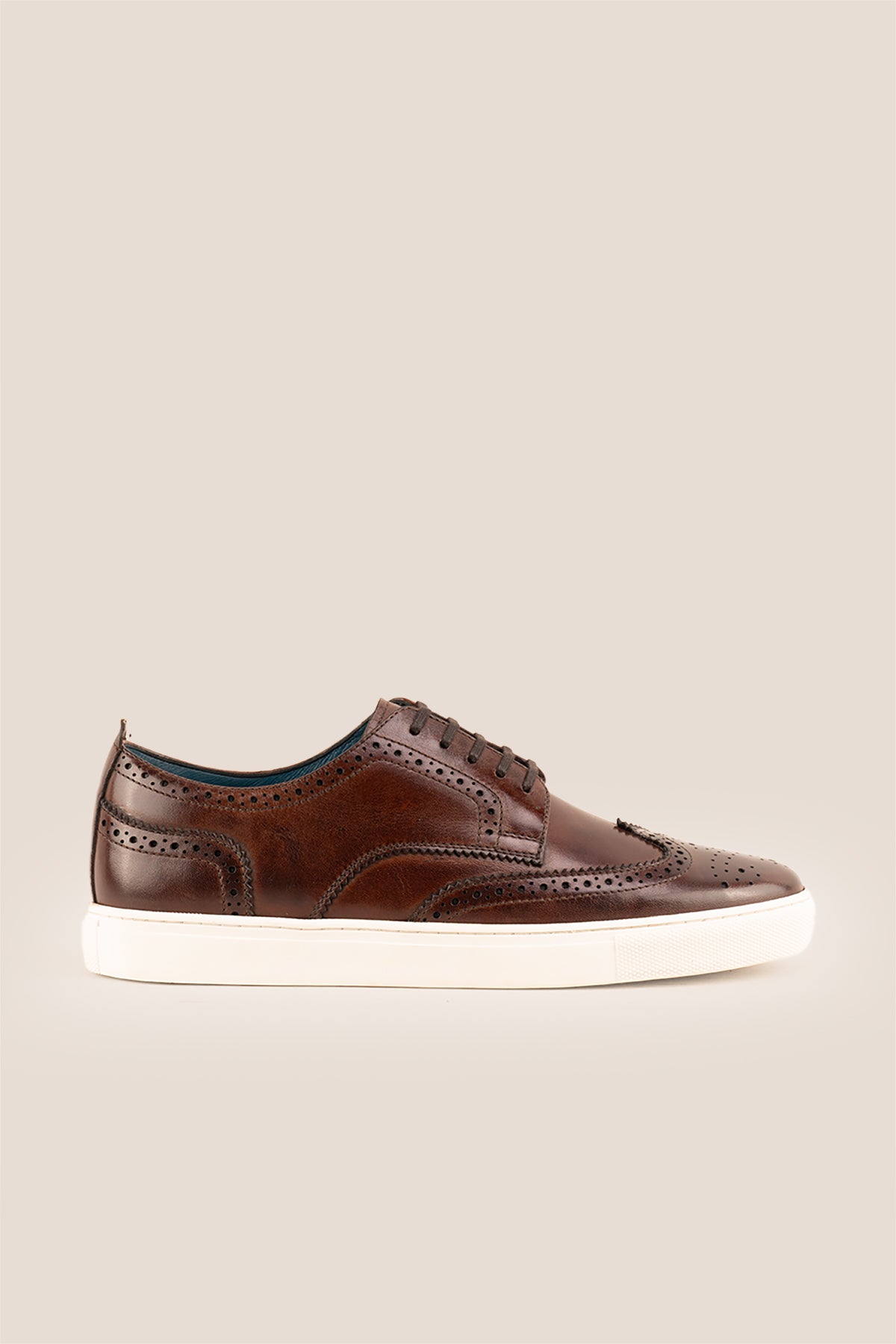 Stan Brown wingtip brogue trainer shoes for men, crafted from premium leather with classic wingtip detailing and modern trainer sole.
