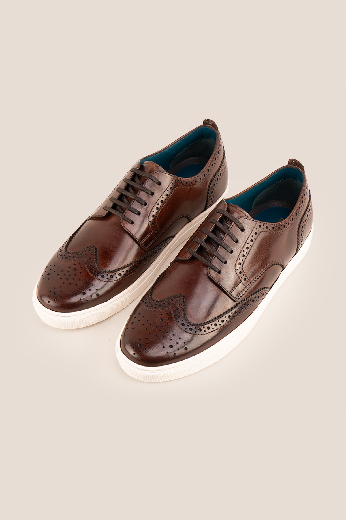 Stan Brown wingtip brogue trainer shoes for men, crafted from premium leather with classic wingtip detailing and modern trainer sole.