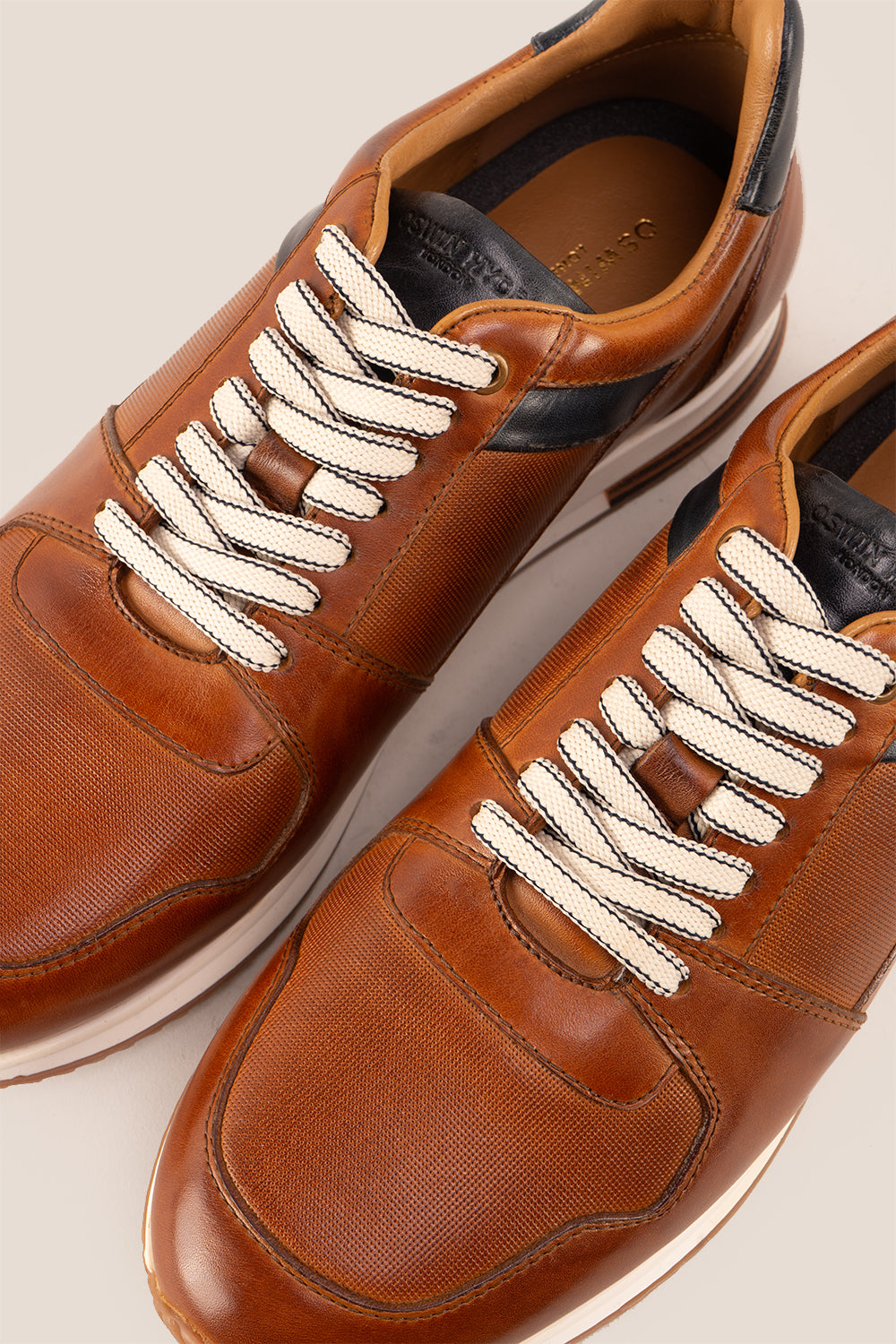 Rory Tan leather sneakers for men, featuring a classic design that exudes timeless elegance. 