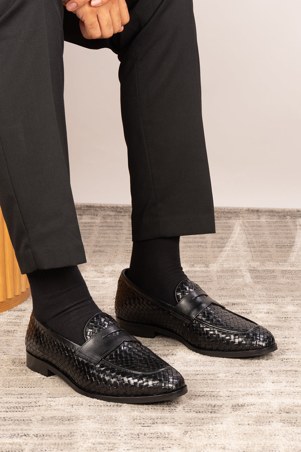 Santiago Black woven leather loafers for men displayed in a side profile, showcasing the textured leather and sleek, elegant silhouette suitable for formal or casual wear.