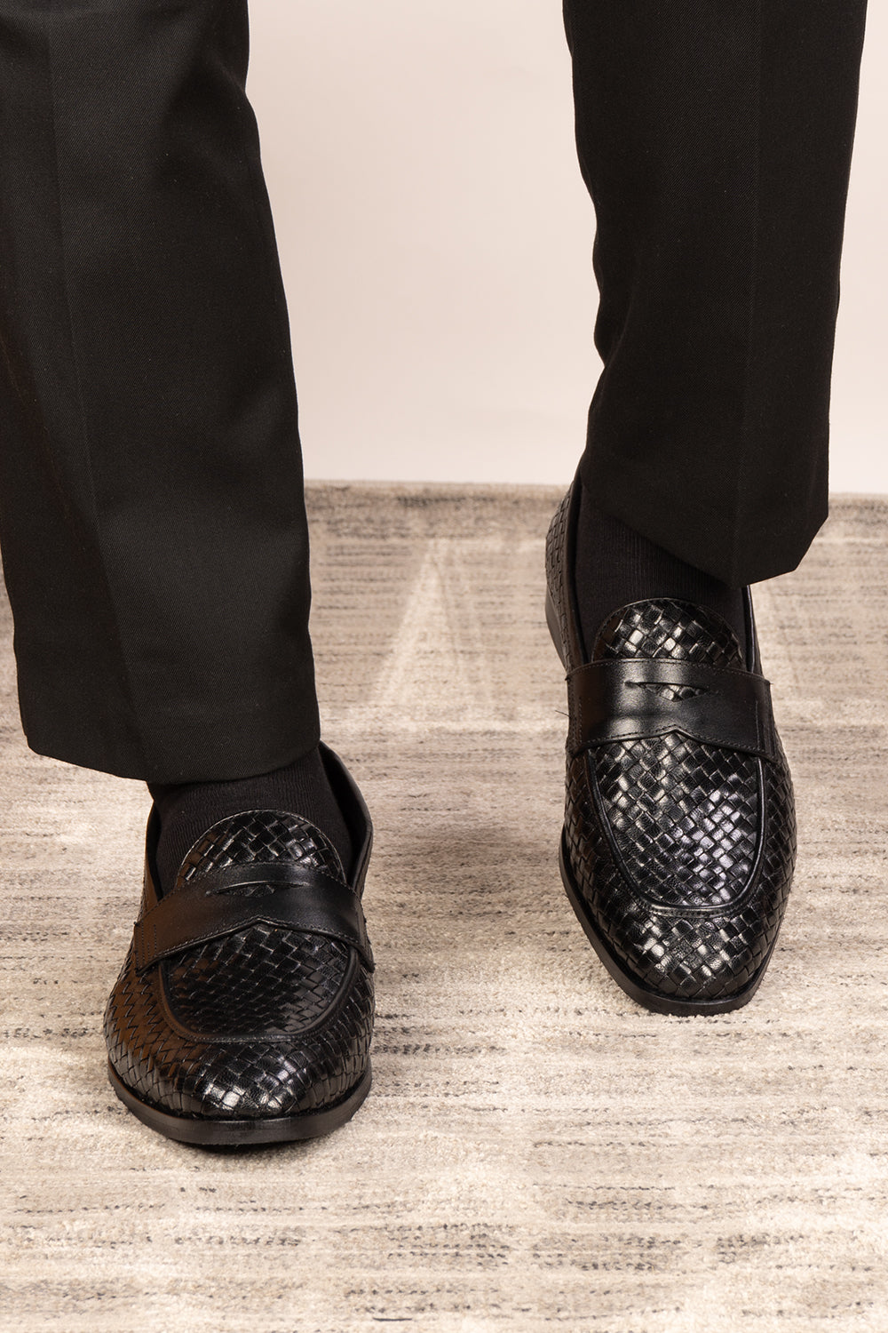 Santiago Black woven leather loafers for men displayed in a side profile, showcasing the textured leather and sleek, elegant silhouette suitable for formal or casual wear.