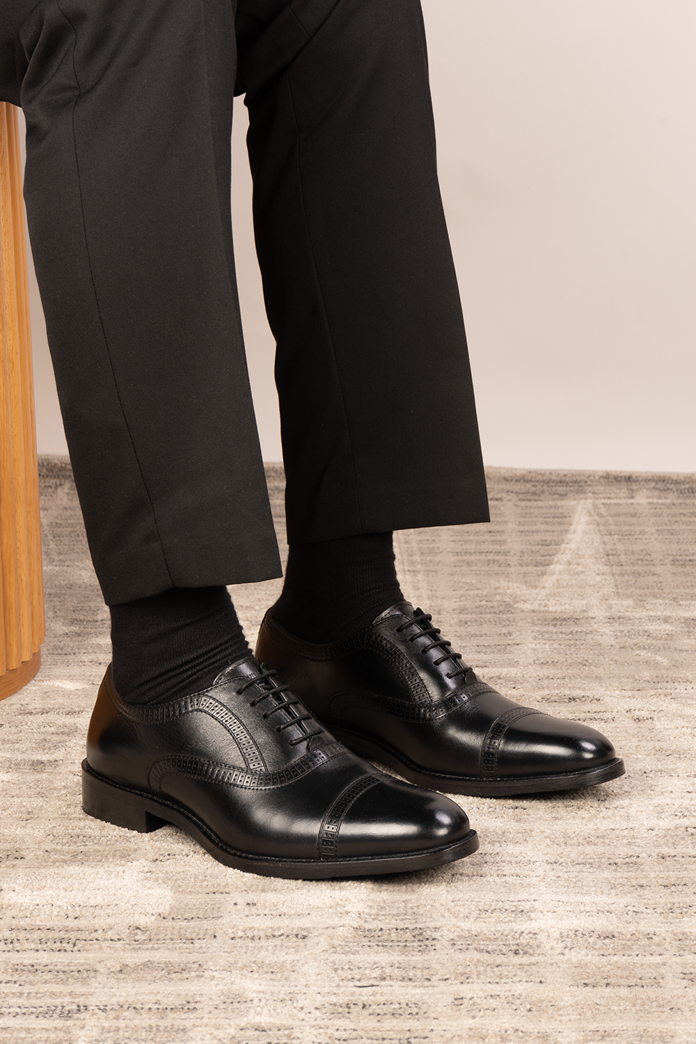 Creed black leather men's brogue shoes with a classic five-eyelet toecap design, featuring polished finish and timeless sophistication