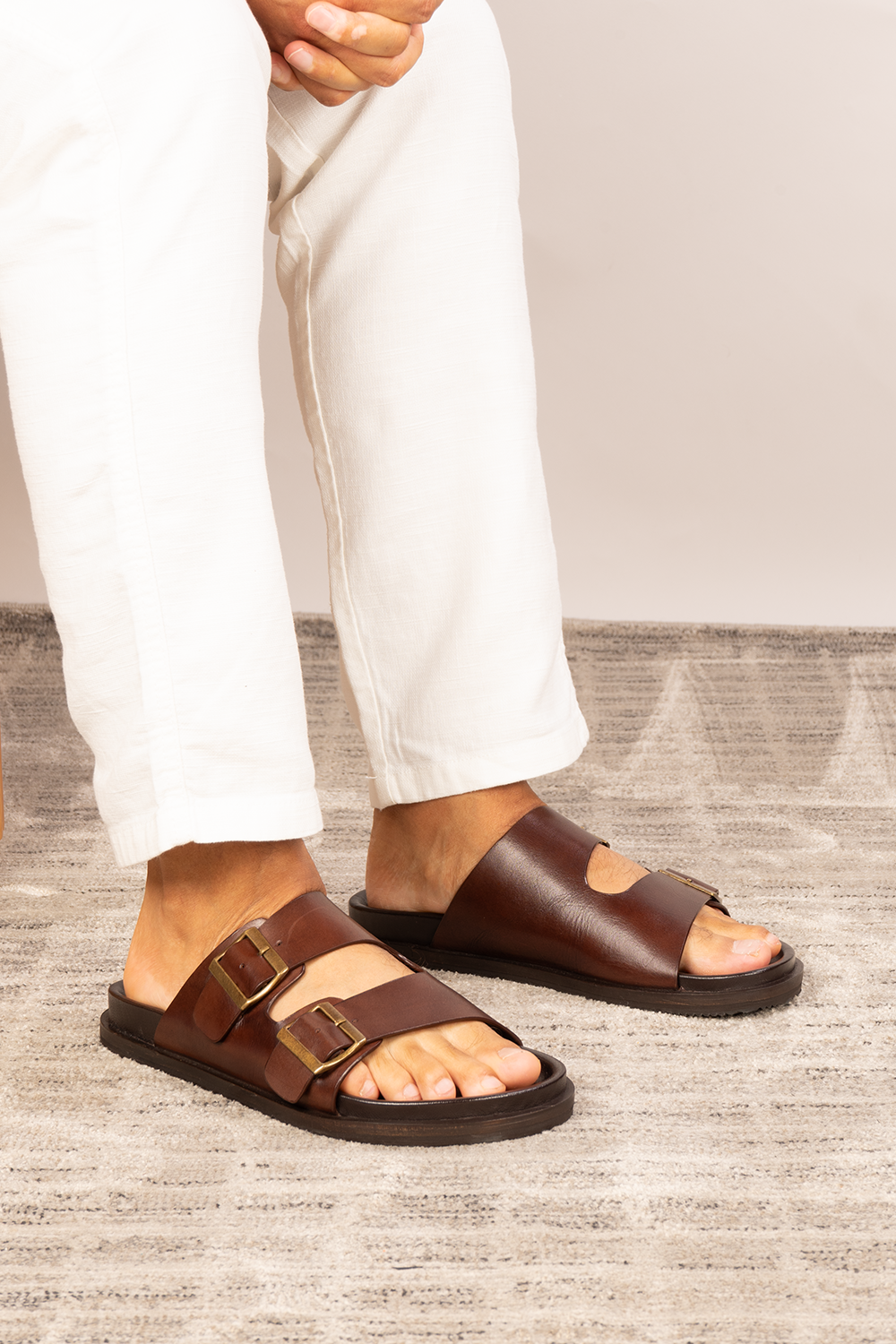 Jude Brown leather men's sandals with broad twin buckle straps and a contoured footbed, designed for comfort and summer style.