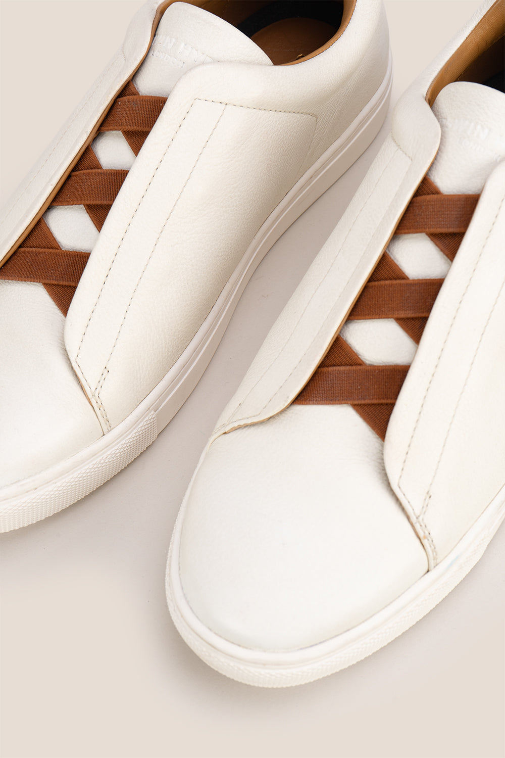 Smudge White sneaker is crafted from soft, milled leather, perfect for both casual and formal occasions. No need to tie laces, secure elasticated fit 