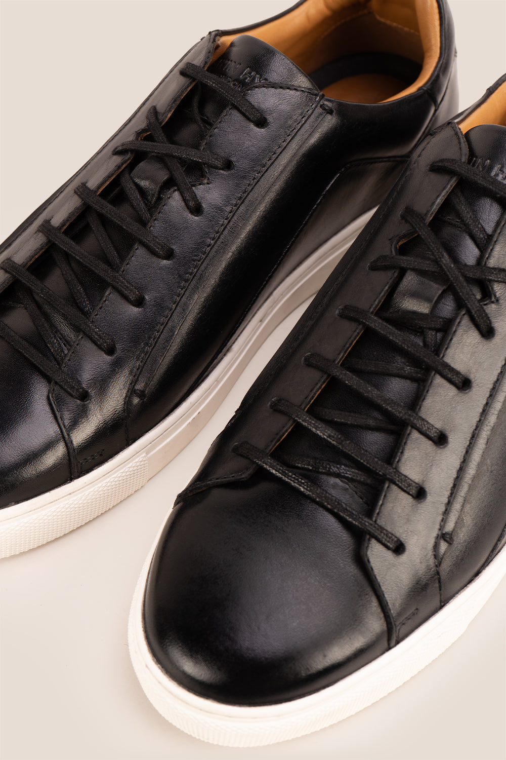 Hayes Black leather sneakers for men, featuring a classic seven-eyelet design that brings a touch of sophistication to your casual wardrobe. Made from premium leather