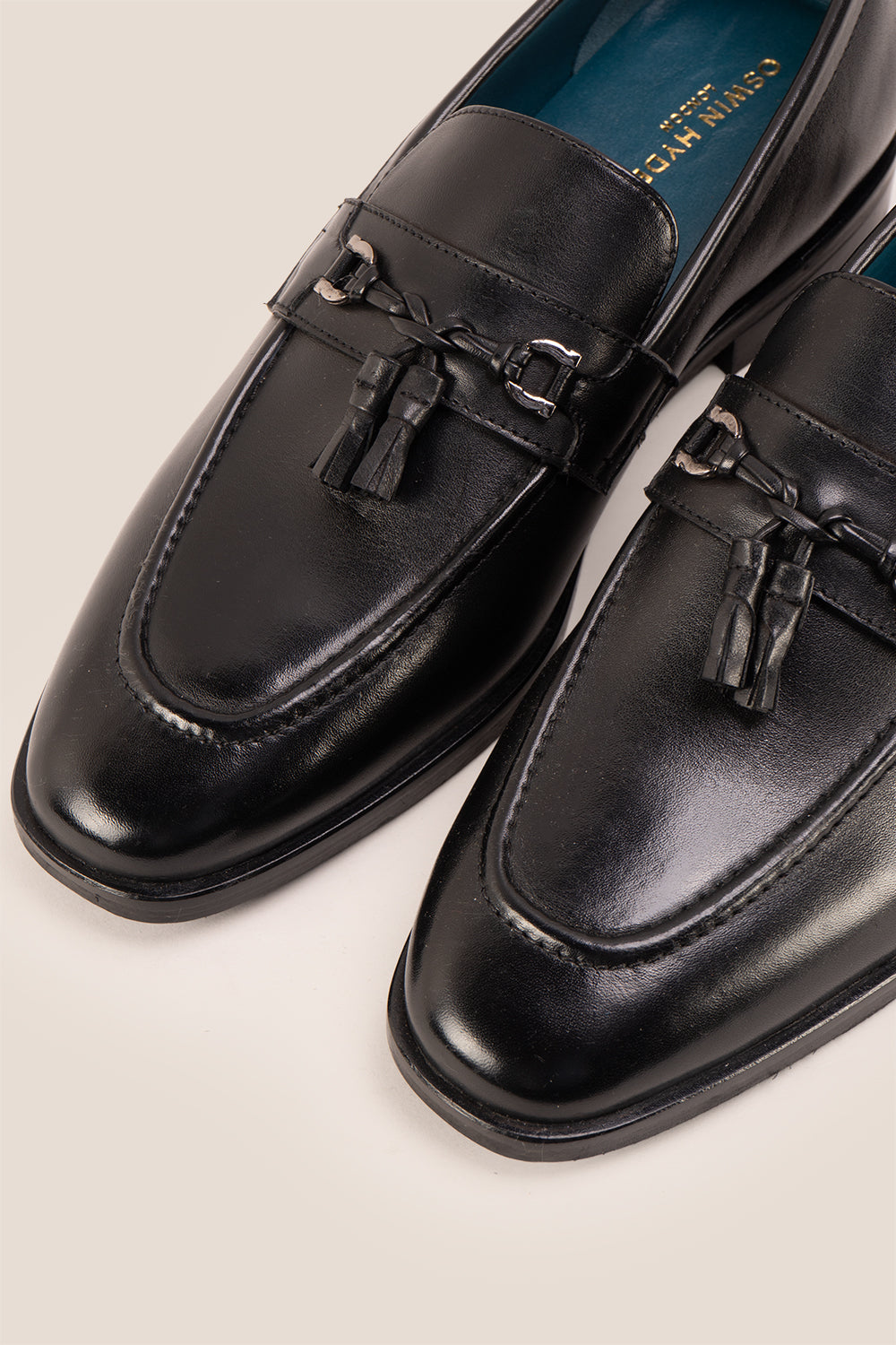 Emmet black leather loafers for men with trim and tassel detail, crafted from premium leather for refined casual and formal wear.