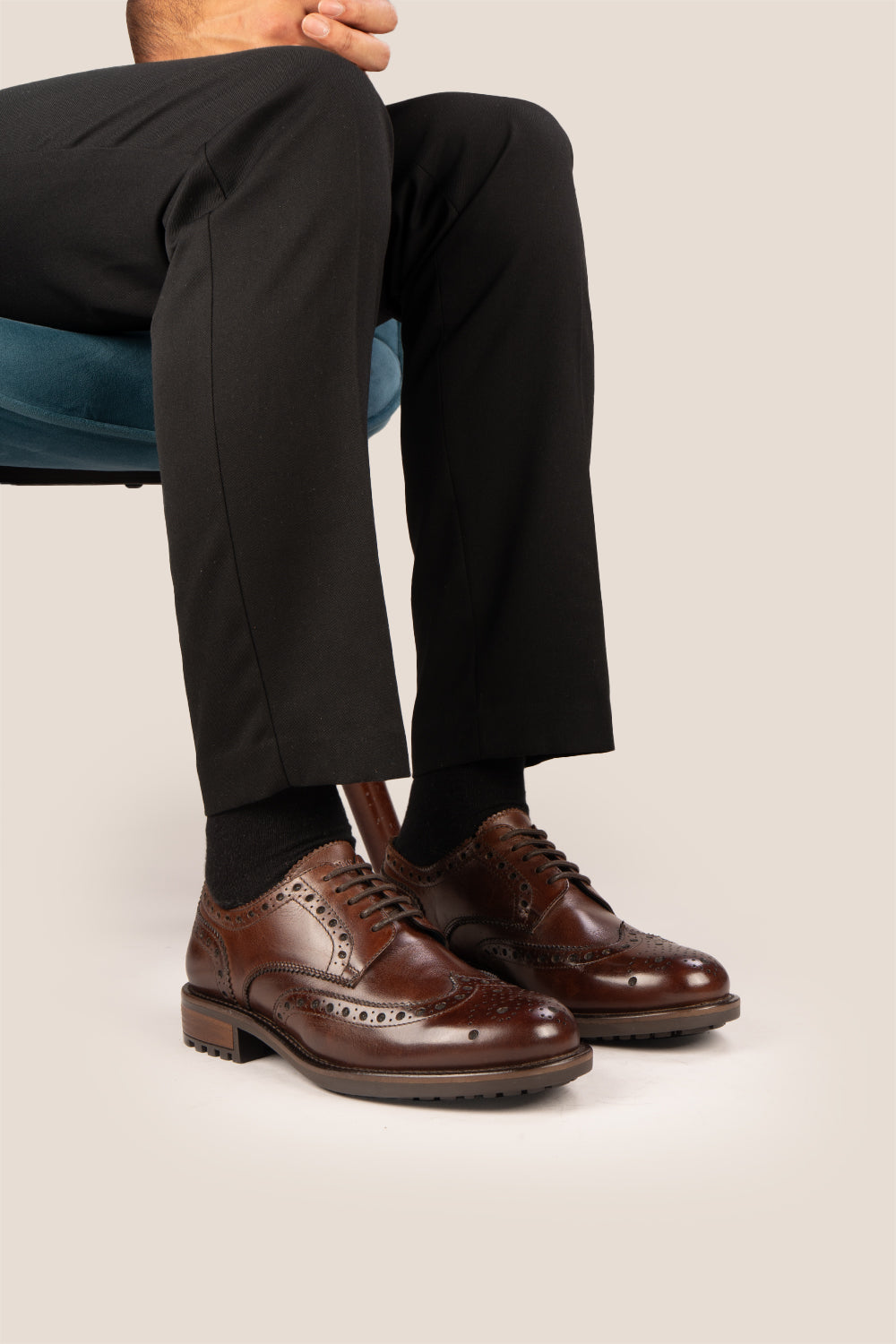 George Brown leather shoes for men. Featuring a five-eyelet wing cap brogue design, these shoes offer timeless style and comfort