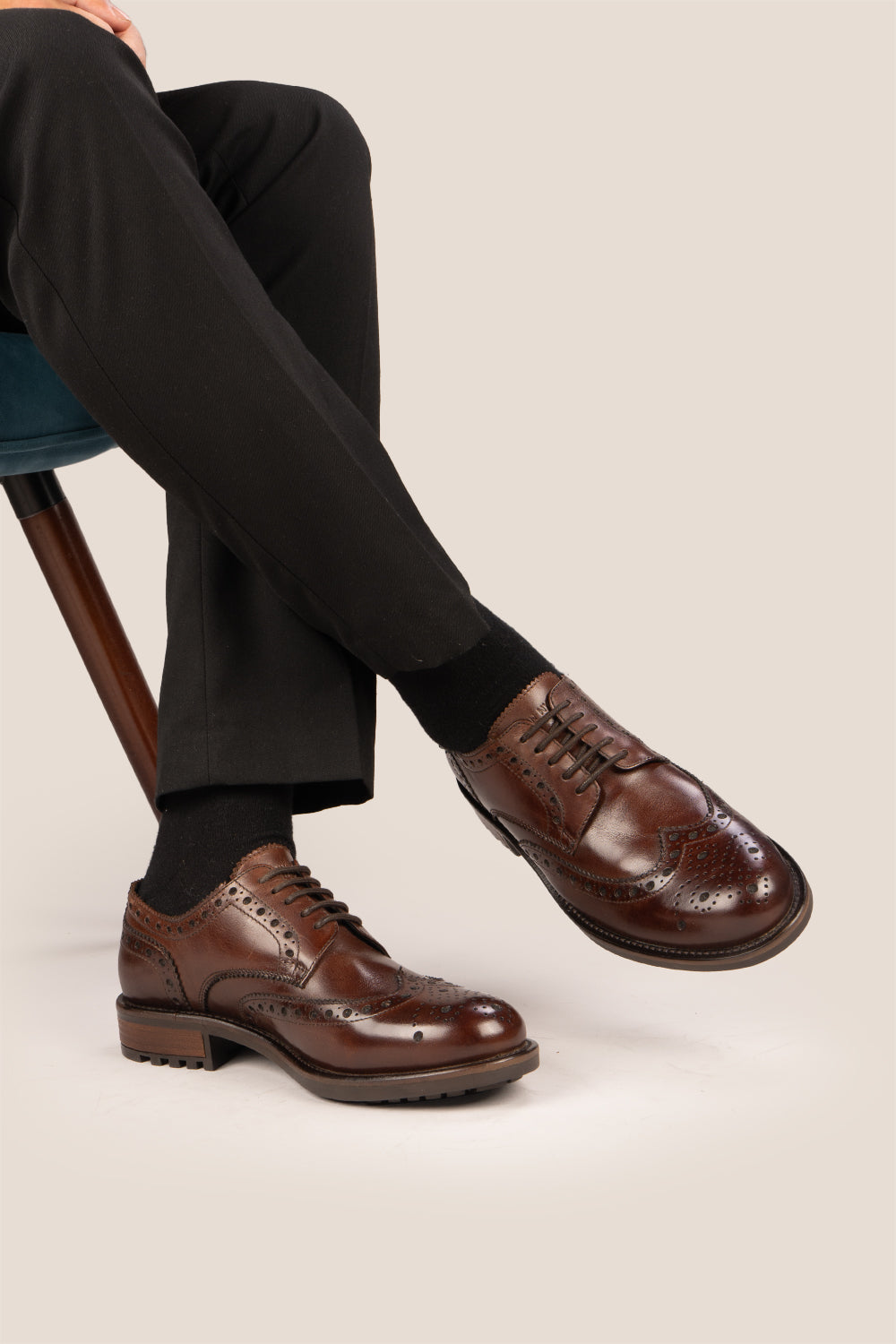 George Brown leather shoes for men. Featuring a five-eyelet wing cap brogue design, these shoes offer timeless style and comfort