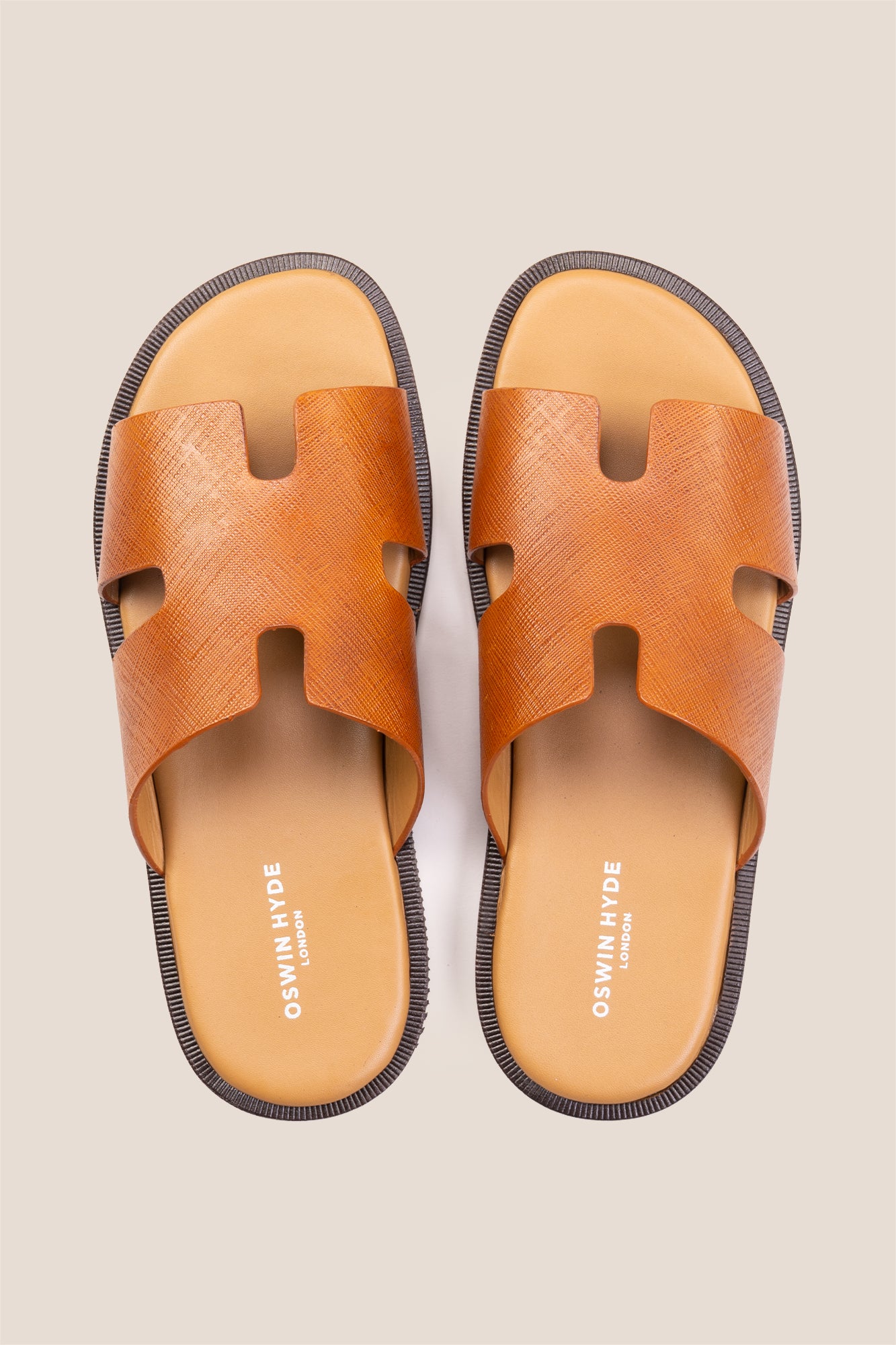 Men’s Phoenix Tan sandals in premium Saffiano leather featuring the signature hyde strap H-frame design.