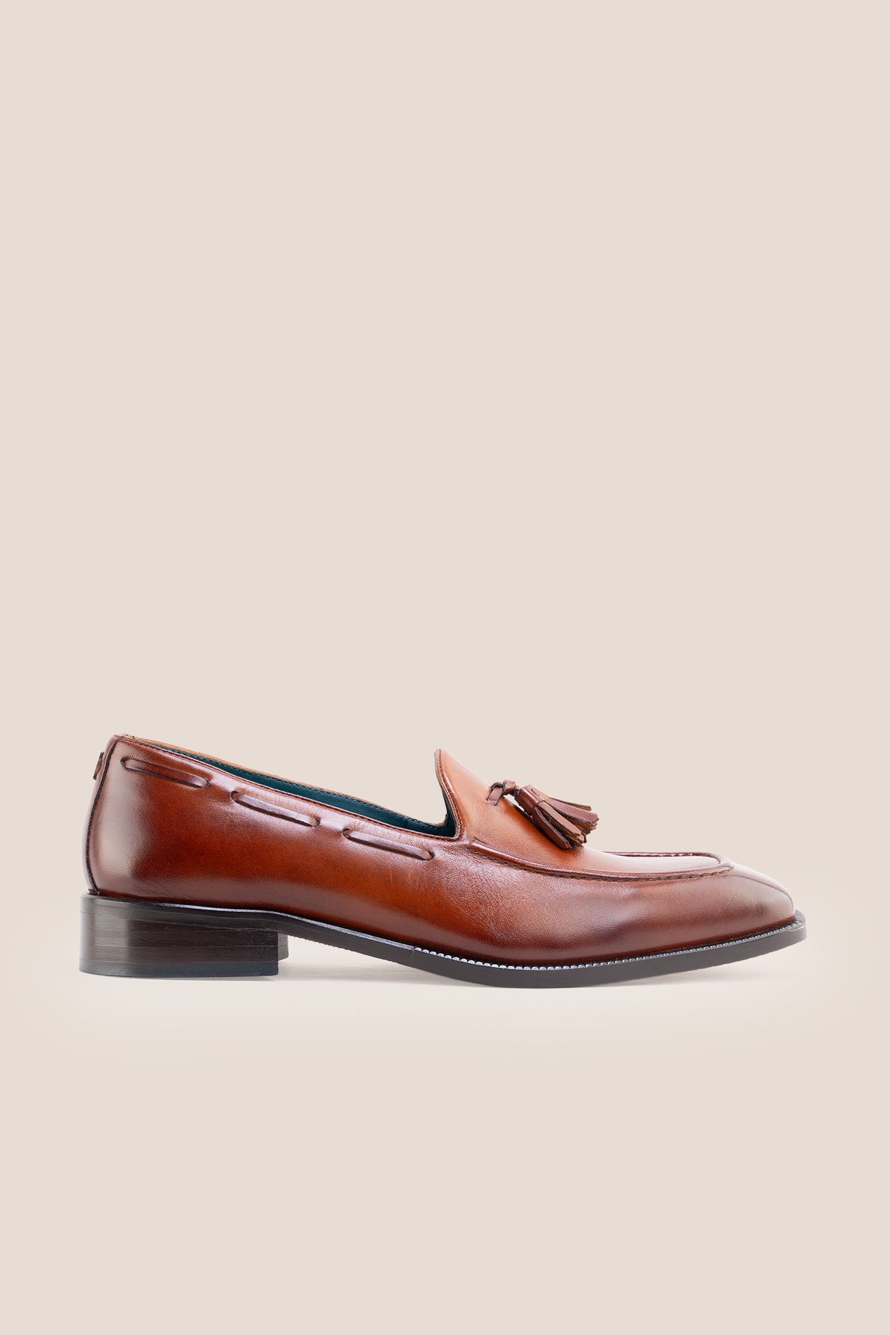The men's smart tan loafers showcase signature twin tassels and rich full-grain leather, perfect for weddings, business occasions, and summer tailoring.
