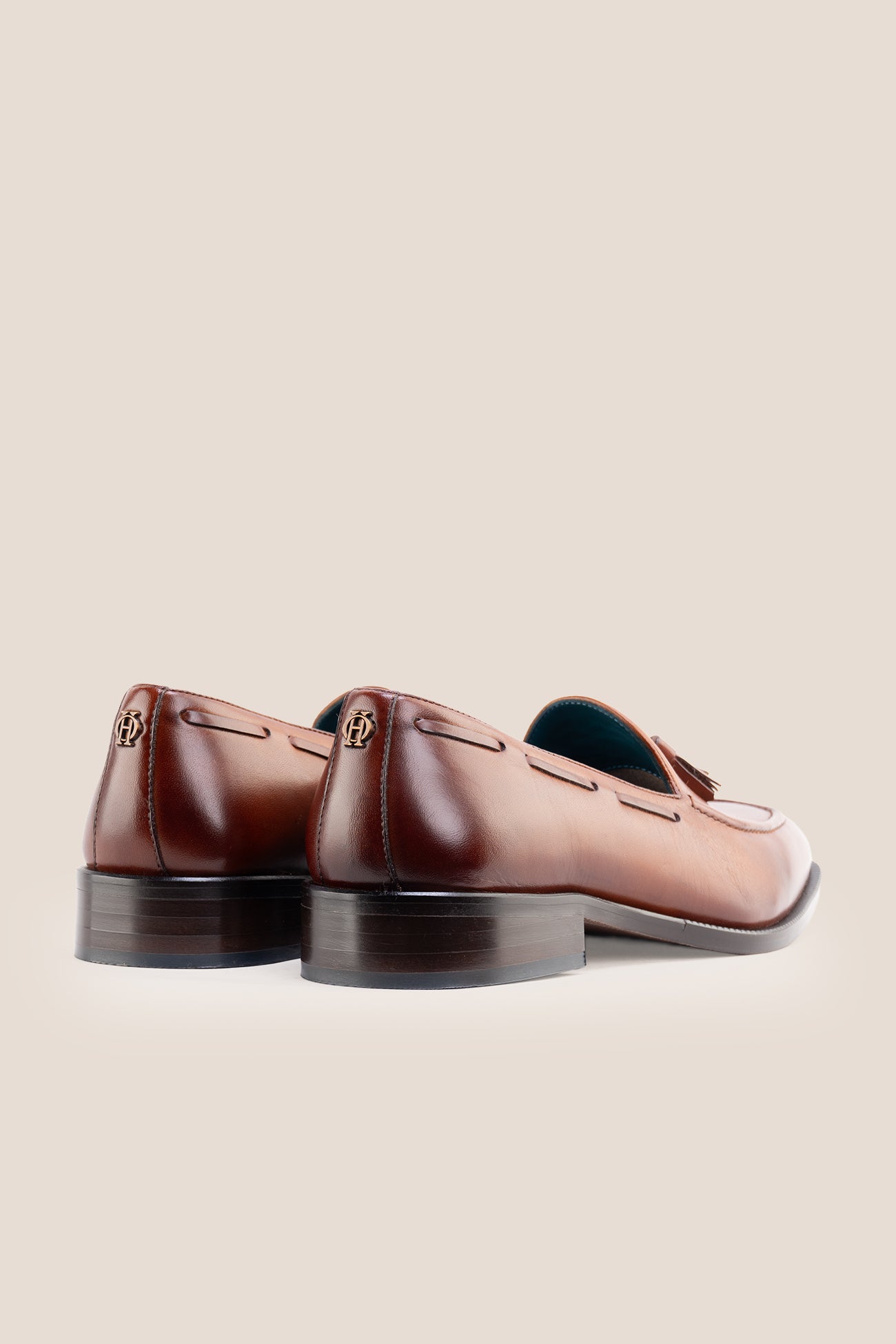 The men's smart tan loafers showcase signature twin tassels and rich full-grain leather, perfect for weddings, business occasions, and summer tailoring.