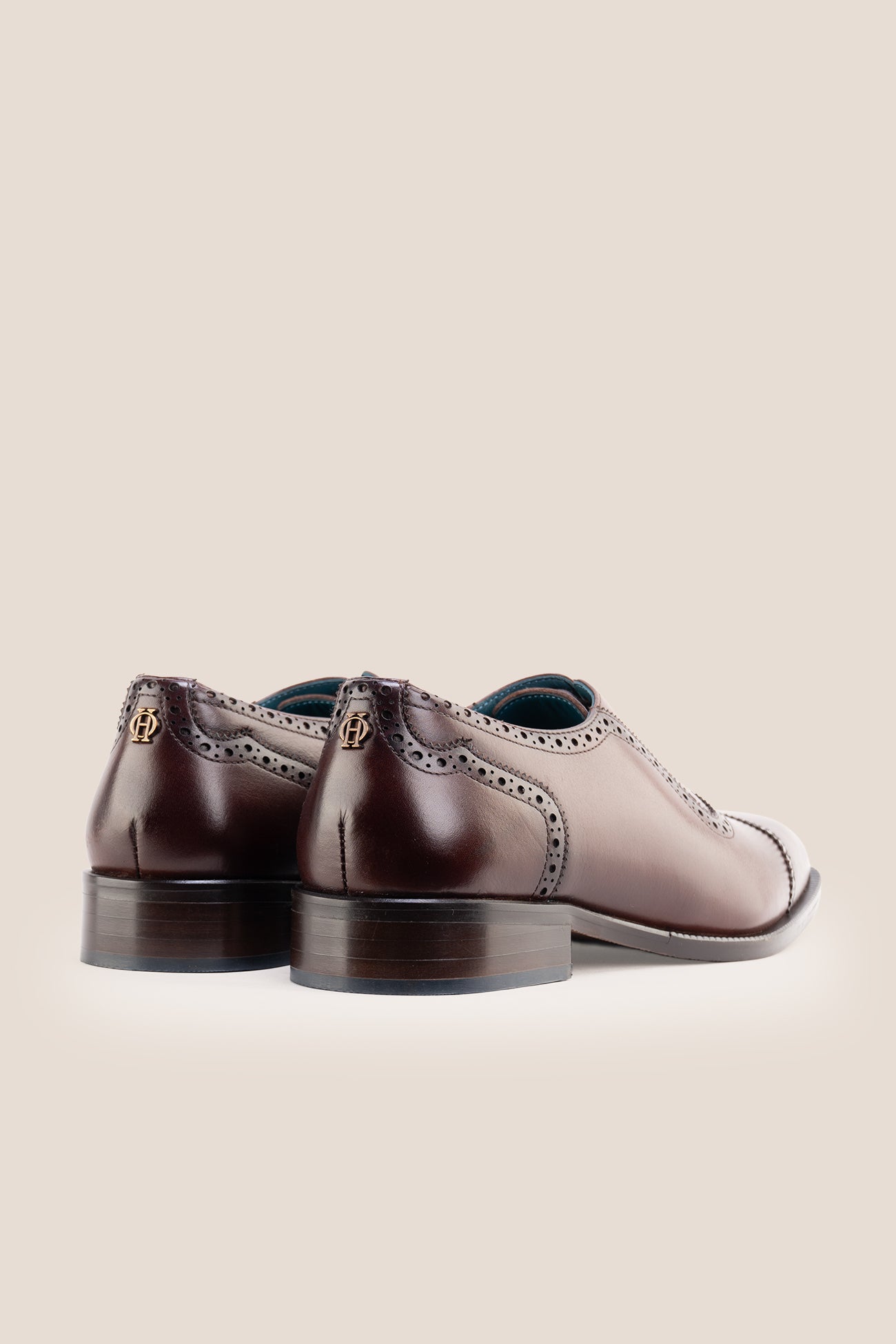 The men's smart brown oxford shoes showcase a refined cap-toe design with delicate brogue detailing and rich full-grain leather, perfect for weddings, formal events, and boardroom attire.