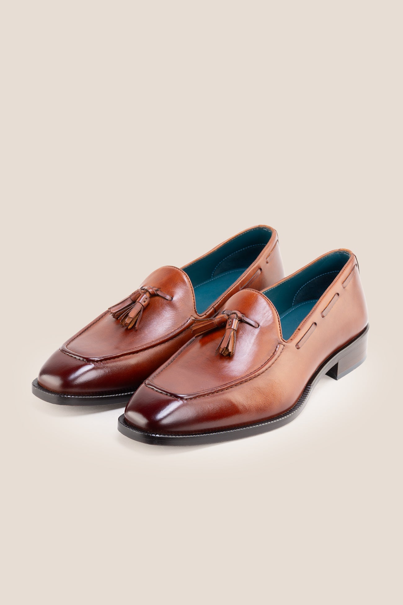The men's smart tan loafers showcase signature twin tassels and rich full-grain leather, perfect for weddings, business occasions, and summer tailoring.